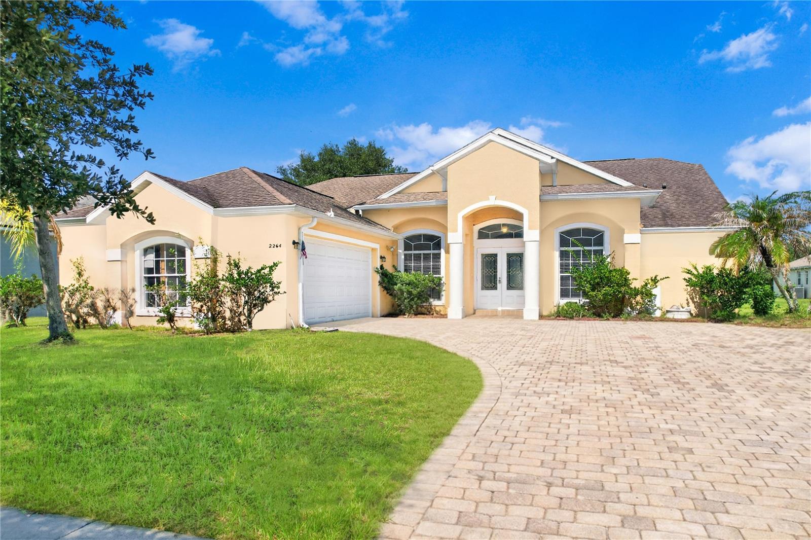 Virtually Staged. This 4-bedroom, 2-bathroom split bedroom floor plan home in Oak Hammock Preserve offers 2,233 square feet of smart design that buyers search for and rarely find.
Expansive high ceilings, a paver driveway, palm tree curb appeal, and double-door entry give this home a presence from the street that carries all the way through.
Inside, you will find a separate formal living room and formal dining room, ideal for hosting and special occasions. The kitchen is genuinely well-designed with solid cabinet and counter space, a closet pantry, breakfast bar, and a separate kitchen nook that opens into its own family room, giving you distinct spaces for everyday living and entertaining alike.
The primary suite is tucked away from the secondary bedrooms with a walk-in closet, dual vanities, garden tub, and separate shower. Three additional bedrooms give you the space to host guests, set up a home office, or simply have room to spread out.
Step outside to the covered lanai and take in a spacious backyard with plenty of room to breathe. This is where Florida living happens.
Shopping, dining, schools, major roadways, and Central Florida attractions are all within easy reach. Homes with this combination of size, layout, and location do not sit long.
Call today to schedule your private showing.