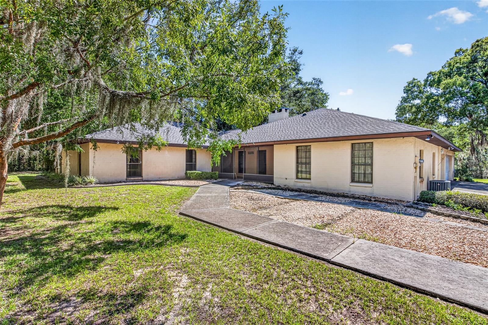 3-Acre Private Oasis with In-Law Suite & New 2025 Roof – No HOA!
Rare find in Rainbow Lakes Estates! Situated on an expansive 3-acre lot, this unique property offers the ultimate combination of privacy, space, and multi-generational flexibility. Best of all, enjoy the benefits of a deed-restricted community with no HOA fees or restrictions. Bring your toys and your vision—this property is a blank canvas ready to become your ultimate dream estate.
The main residence is filled with character, featuring beautiful natural woodwork and an abundance of windows that flood the home with natural light. Upon entering, you are greeted by a functional entryway with a full wall of floor-to-ceiling cabinets. To the right, a cozy family room boasts a stunning, full-wall stone fireplace, seamlessly connected to the generously sized kitchen via a convenient breakfast bar. The kitchen is a delight, offering endless cupboard and counter space, along with a bright breakfast nook overlooking the sprawling backyard.
Just past the family room, the home opens up into a dramatic, vaulted formal living area. French doors lead out to a spacious, screened lanai—perfect for enjoying peaceful Florida evenings.
Flexible Living & In-Law Suite:
The bedroom wing features two spacious guest rooms sharing a completely remodeled guest bath, alongside a primary suite with its own newly updated ensuite bathroom. Skylights and solar tubes keep the hallways bright and airy. Off the kitchen, a massive bonus room awaits your touch—perfect for a game room, formal dining, den, or home office.
The crown jewel of this floor plan is the attached in-law apartment with private entrance. Complete with its own kitchen, living area, and a separate bedroom with a half bath (and immediate access to a full bath that can be closed off for total privacy), this space is perfect for multi-generational living, guests, or a private studio.
Garages & Mechanicals:
The oversized, deep garage with 3 stalls is a hobbyist's dream, featuring a wall of storage cabinets and plenty of room for vehicles and outdoor toys. Utility options abound with a dedicated laundry setup in the garage.
Peace of Mind & Updates:
• Roof: Brand New (Replaced in 2025) – Huge insurance savings!
• A/C: Main unit installed in 2018
• Water Heater: Newer unit installed
With a little bit of TLC and your personal design choices, this incredibly versatile property will easily become a true neighborhood showplace. Don't miss out on 3 acres of pure Florida freedom—schedule your private tour today!
Key Features Cheat Sheet for Showings:
• Acreage: 3 private, wooded acres in Rainbow Lakes Estates
• Layout: 3 BR / 3  and ½ BA Main House + Fully Equipped In-Law Suite
• Bathrooms: All 3 main house bathrooms have been beautifully remodeled
• Outdoor Living: Large screened lanai overlooking a massive, private backyard
• Storage: Floor-to-ceiling built-ins at entry, bonus room, and extensive garage cabinetry
• Location: Minutes from the pristine waters of Rainbow Springs State Park, offering world-class kayaking, swimming, and hiking.

All dimensions are approximate, See floor plan. Interested parties should verify measurements and information.