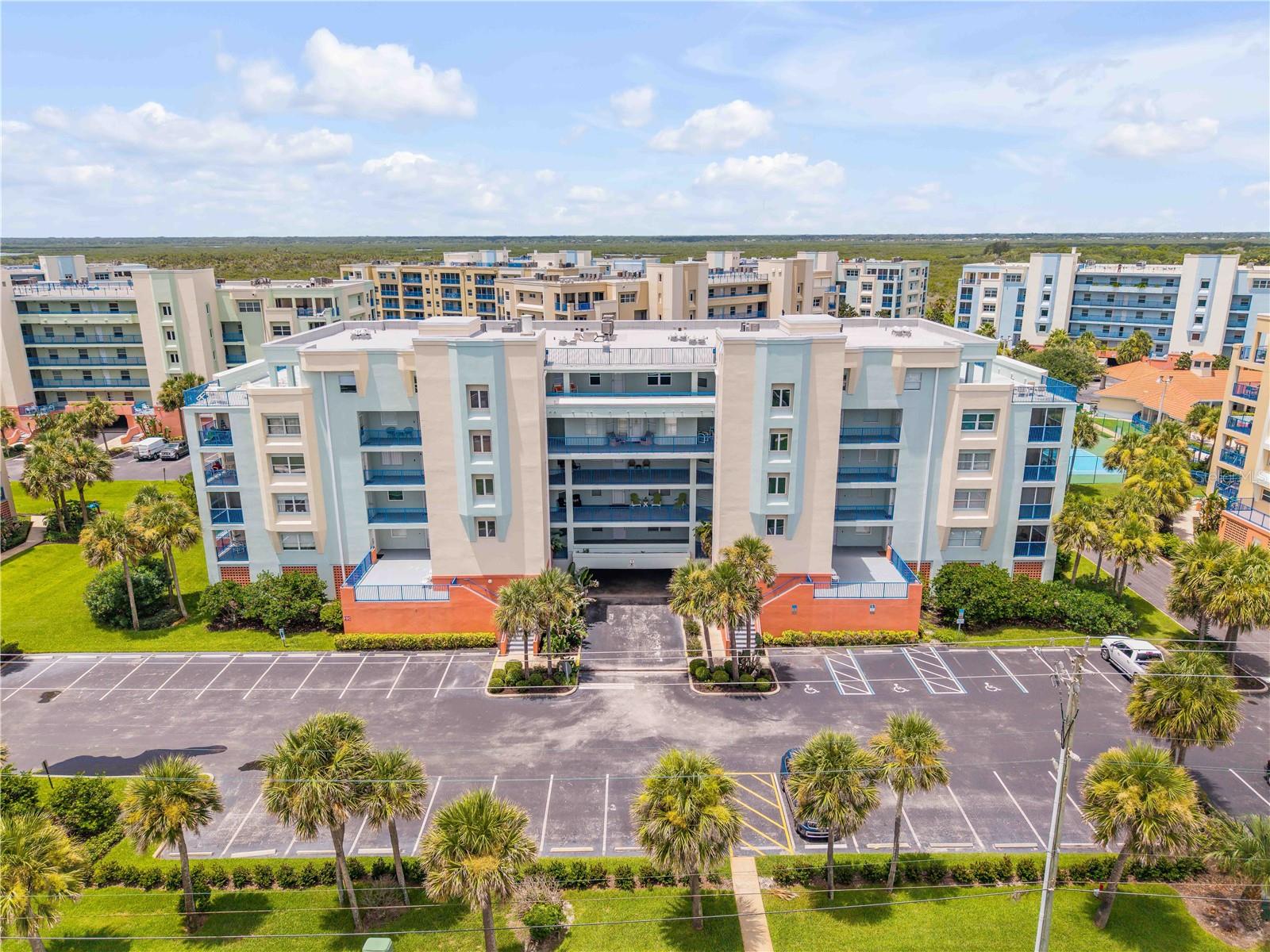 Beautifully updated 2-bedroom, 2-bath condominium located in the gated resort-style Ocean Walk community. This spacious residence features an open floor plan with marble-look ceramic tile flooring throughout, an updated kitchen with quartz countertops, tile backsplash, stainless steel appliances, and ample cabinet space. The primary suite offers a walk-in closet with custom built-ins and a tastefully remodeled en-suite bath. The screened balcony provides additional outdoor living space, and the unit also includes an in-unit laundry room, secure underground parking, and a private storage room. Ocean Walk offers private deeded beach access, two clubhouses, two heated pools, spas, fitness centers, saunas, tennis courts, shuffleboard, bocce ball, basketball courts, and scenic walking trails through protected conservation areas. Conveniently located just minutes from Flagler Avenue and historic Canal Street, you'll enjoy easy access to popular restaurants, boutiques, art galleries, and live entertainment. New Smyrna Beach is also within easy reach of Central Florida's renowned attractions, Daytona International Speedway, and three airports. Whether you're searching for a primary residence, vacation home, or investment opportunity, this exceptional property is ready to enjoy.