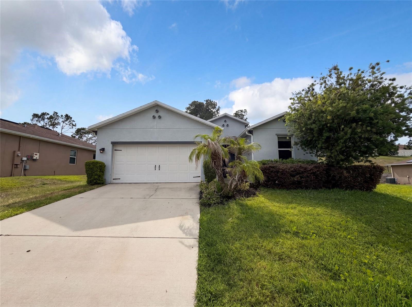 Virtually Staged. Set in Clermont's Highland Groves, this single-story home was built in 2016 and has about 1,873 square feet of bright, open living, freshly painted top to bottom and ready to move right in. The great room rolls right into a kitchen that's genuinely fun to cook in, with granite counters, a big island under warm pendant lights, stainless appliances, and all the cabinet space you've been wishing for. Off the entry there's a flex spot that can be whatever you need, whether that's a dining room for Sunday dinners or a quiet home office. The wood-look floors lead back to a primary suite that feels like its own little getaway, with an en suite bath and a walk-in closet you won't have to fight over. Down the hall, two more bedrooms and a second bath keep things flexible, and the indoor laundry room quietly makes life easier. Out back, the yard is made for morning coffee and weekend cookouts in the Florida sunshine, and the two-car garage means everything finally has a home. Close to shopping, dining, and an easy hop to Orlando, this one's just plain easy to love.. Included 100-Day Home Warranty with buyer activation