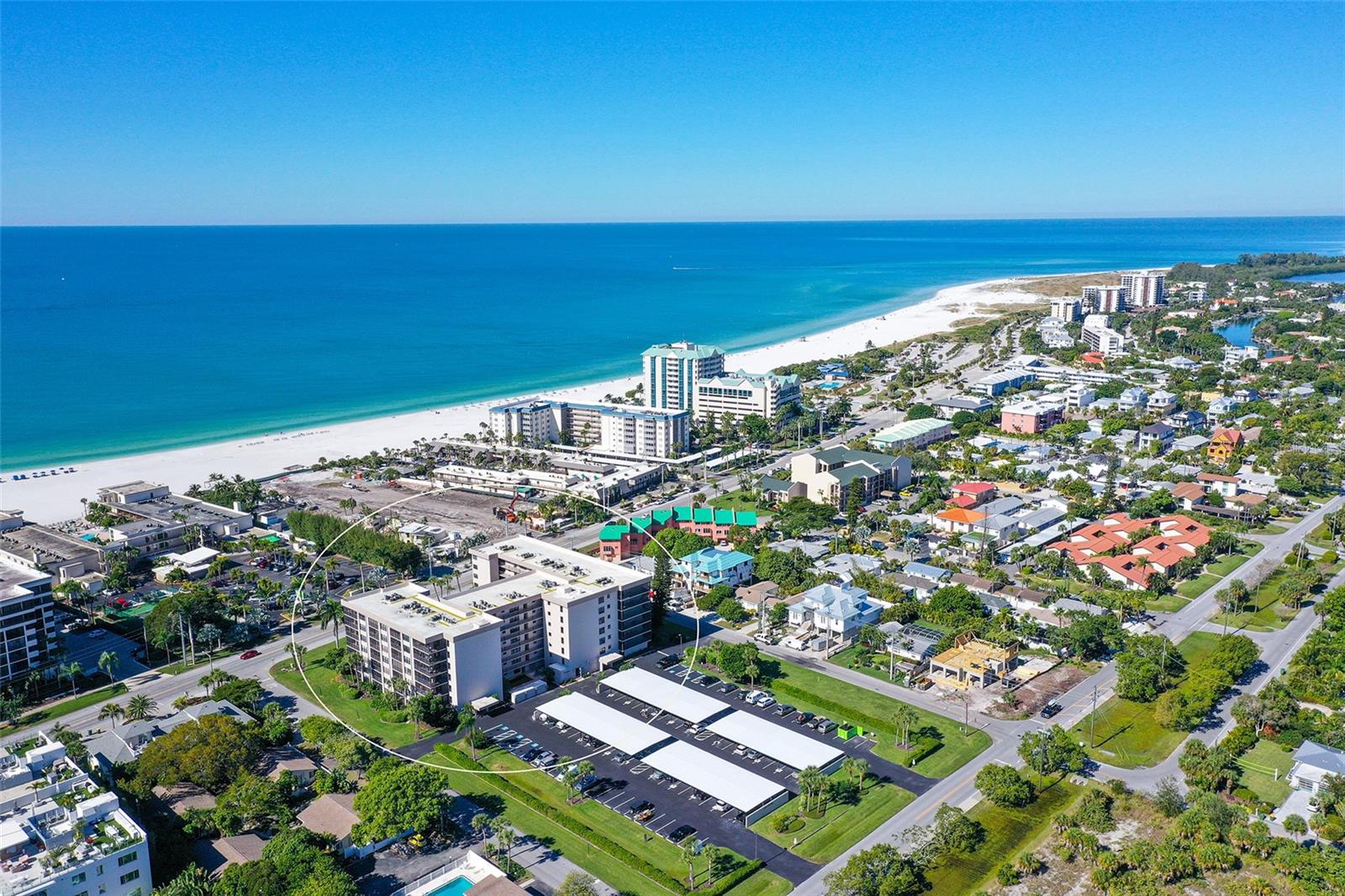 Lido Towers on Lido Key. This beautifully appointed 2-bedroom, 2-bath first-floor residence offers the perfect blend of coastal charm and effortless living just steps from the pristine sands of Lido Beach. Spanning approximately 1,293 square feet, the thoughtfully designed split-bedroom floor plan provides both privacy and comfort, while the spacious living and dining areas create an inviting atmosphere for relaxing or entertaining. Large windows and sliding glass doors fill the home with natural light and enhance the easy indoor-outdoor Florida lifestyle. The well-equipped kitchen features ample cabinetry and counter space, making meal preparation simple whether hosting guests or enjoying a quiet evening in. The primary suite offers generous closet space and a private en-suite bath, while the guest bedroom and second bath provide comfort and convenience for visitors. Offered fully furnished and truly turnkey, this residence is ready for immediate enjoyment — simply bring your suitcase and begin living the island lifestyle. The first-floor location provides easy access and added convenience, making everyday living effortless. Lido Towers amenities include a heated pool and spa, sauna, clubhouse, secure entry, elevator access, and assigned covered parking. Ideally located just moments from the beach and minutes from the world-class dining and shopping of St. Armands Circle, this is an exceptional opportunity for a full-time residence, seasonal retreat, or investment property in one of Sarasota’s most desirable coastal communities with private beach access!