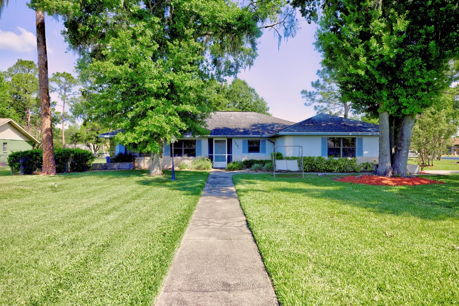 Welcome to this beautifully maintained 3-bedroom, 2-bathroom home situated on a desirable corner lot in the wonderful Golf Hammock community. Featuring a split floor plan for added privacy, this home combines comfort, functionality, and thoughtful updates throughout. Recent improvements include a 2018 roof and an updated air conditioning system with a UV light for enhanced air quality. Skylights bring in abundant natural light, creating a bright and inviting living space. The updated kitchen is a standout, showcasing elegant granite countertops, soft-touch cabinetry, and sleek stainless-steel appliances—perfect for both everyday living and entertaining. The spacious sunroom has been upgraded with energy-efficient Thermopane windows, offering a relaxing space to enjoy year-round. Step outside to enjoy a fenced-in yard and a peaceful pond view from the front of the home. Additional features include a 10x18 shed for extra storage and full wheelchair accessibility for added convenience. This home offers a perfect blend of modern updates, practical design, and scenic surroundings—schedule your showing today!
