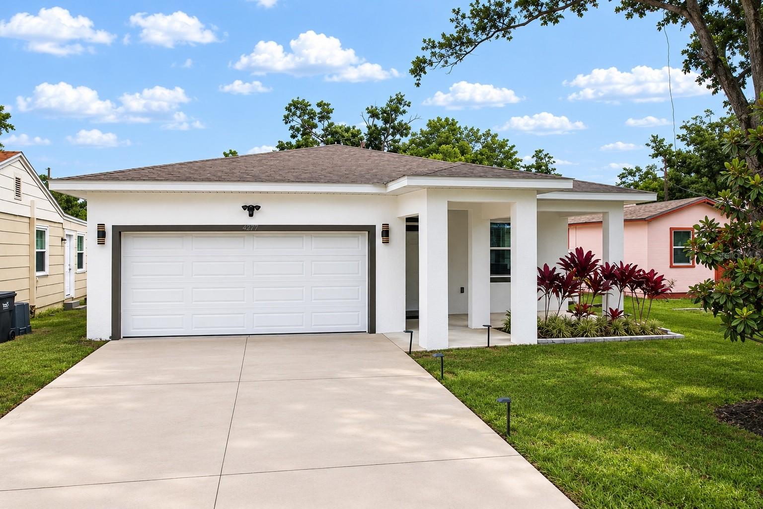 Built in 2024 and perfectly positioned in the heart of St. Petersburg, this beautifully designed 4-bedroom, 2 full bathroom, 1 half bathroom home offers the ideal combination of modern construction, energy efficiency, and an unbeatable central location. Situated in a non-flood zone and non-evacuation zone with no HOA or CDD fees, this property provides both peace of mind and everyday convenience. Inside, you'll find over 2,100 square feet of thoughtfully designed living space featuring luxury waterproof vinyl plank flooring throughout the main living areas and an open-concept floor plan that seamlessly connects the kitchen, dining, and living spaces. The kitchen was designed with both style and function in mind, showcasing quartz countertops, wood cabinetry with soft-close features, premium stainless steel appliances, a dedicated pantry, and a large center island with additional seating for gathering with family and friends. The spacious primary suite serves as a private retreat with two closets featuring custom closet systems and a beautifully appointed ensuite bathroom complete with dual sinks with LED mirrors, quartz countertops, a seamless glass enclosed walk-in shower, and a soaking tub with a second shower head. The split-bedroom floor plan provides privacy for family members and guests, while a dedicated laundry room adds everyday convenience. Step outside to your fully fenced backyard oasis where vinyl fencing surrounds the property, creating a private setting perfect for entertaining, relaxing, or enjoying Florida's beautiful weather. Designed for efficiency and durability, the home is equipped with hurricane impact windows and doors, foam attic insulation, upgraded wall insulation, and an 18 SEER inverter AC system to help keep utility costs low year-round. The garage is equipped with an EV charger and a newly added overhead storage racks to maximize organization. One of the standout features of this location is its proximity to Neri Park, which recently underwent a $10 million renovation featuring upgraded walking trails, a new playground, adult fitness areas, scenic lake views, and an upcoming dog park. Downtown St. Petersburg is less than 15 minutes away, offering waterfront parks including the iconic St. Pete Pier, award-winning museums, local boutiques, vibrant nightlife, and year-round festivals and events. With quick access to Interstate 275, commuting to Tampa, Clearwater, and the Gulf beaches is effortless, while travelers will appreciate being approximately 20 minutes from both St. Pete-Clearwater International Airport and Tampa International Airport. Whether you're spending the day exploring downtown St. Petersburg, enjoying the area's beautiful parks, or relaxing on the award-winning Gulf beaches, this exceptional home places you right in the center of everything that makes Tampa Bay one of Florida's most desirable places to live. Schedule your showing today!