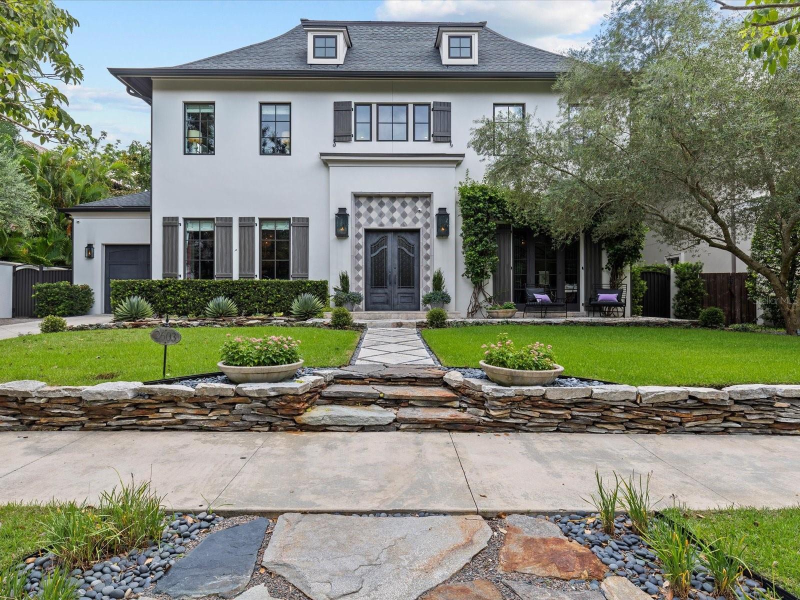 Under Contract!  Back up offers are welcome. A Once-in-a-Lifetime Home, custom designed by Jordan Behar Architecture and the interior by Franco Pasquale Design Associates, offers a harmonious blend of modern and traditional styles, with French Normandy inspiration. Featuring 5 bedrooms and 4.1 baths, this home is rich in thoughtful details, premium materials, and expert craftsmanship. Exterior Structural Features: Constructed with durability in mind, this home features block construction, reinforced trussed roofing with metal caps, and Miami-Dade hurricane-rated fiberglass windows. Exterior architectural highlights include hand-painted shutters, stone knee wall, and travertine walkway surrounded by mature landscaping with Tabebuia and Olive trees that complement the home's aesthetic. The Backyard has premium grass turf, saltwater extra deep pool and the canopy of a beautiful Grand Oak. The scandanavian-inspired interior emphasizes clean lines, concrete floors, and a neutral color palette, providing an elegant backdrop for showcasing artwork. Upon entering through custom metal doors, guests are welcomed into a grand foyer with etched concrete floors and a wrap-around staircase with custom handrail and banisters. The main level is thoughtfully designed with four primary rooms, all filled with natural light. Flexible spaces include an office that doubles as a guest bedroom, and the living room expands seamlessly by opening an accordion glass wall to incorporate the outdoor living area. The heart of this home is its meticulously designed kitchen. It features a striking wood and mixed metal tiara hood as the center of the room, a raised walnut island bar, and separate bar nook. Equipped with top-of-the-line Thermador appliances: including a (gas-plumbed) induction cooktop, steam oven, traditional wall oven, Bosch dishwasher, and oversized refrigerator—the kitchen blends luxury with functionality. Danby marble countertops from Vermont and expansive commercial-grade picture windows flood the space with natural light, offering unobstructed views of the lush backyard. The first floor also includes a laundry room, an oversized single-car garage, and a convenient half-bath that serves the pool area. Upstairs Layout and Private Spaces: The second floor is split into two distinct wings. The primary wing features a vestibule with coffee bar, a spacious bedroom with sitting area, a dressing room with customer built in cabinets by California Closets and a luxurious bath with separate sinks, a two-person stone tub, marble floors, a multi-head shower, and a private sunbathing balcony. The secondary wing includes additional bedrooms, an entertainment room, a second laundry room, an AV closet, and a fourth bedroom with an ensuite bath overlooking the backyard. Attention to Detail and Custom Features: From oversized baseboards and crown molding throughout to custom-built closets in every bedroom, this home exudes sophistication and thoughtful design at every turn. This property is a true masterpiece, offering timeless elegance, modern functionality, and superior craftsmanship—a rare opportunity to own a home where every detail has been meticulously planned and executed. Walking distance to Bayshore Blvd; Hyde Park Village, Restaurants on Howard, and Palma Ceia Golf and County Club. Quick commute: 10 minutes to Downtown Tampa and TIA.