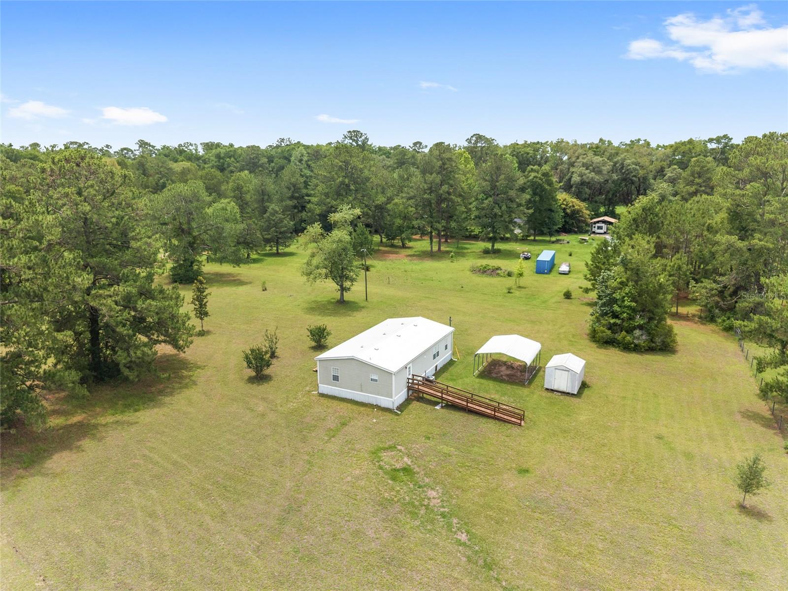Virtually Staged. Enjoy the peace, privacy, and endless possibilities of country living on this beautiful 5.36-acre property featuring a well-maintained 1,248-square-foot manufactured home with 3 bedrooms and 2 bathrooms. Surrounded by open space and natural beauty, this property offers the perfect opportunity for those seeking room to spread out while remaining conveniently close to town.

Inside, you'll find a spacious and functional floor plan featuring a large kitchen with ample cabinetry and workspace, a comfortable living room, a dedicated dining area, and generously sized bedrooms throughout. The primary suite offers a relaxing retreat with a private bathroom complete with a soaking tub, separate shower, and plenty of space to unwind at the end of the day.

The expansive acreage provides countless opportunities for gardening, recreation, livestock, or simply enjoying the privacy and freedom that comes with owning over five acres. Whether you're looking for a primary residence, mini-farm potential, or an investment property, this versatile parcel offers exceptional value.  The property also offers a carport and separate storage shed.

Investors will appreciate the strong rental potential of the home, making it an attractive income-producing opportunity in a desirable rural setting.

For those seeking even more space and possibilities, there is a rare opportunity to purchase the adjacent property, which includes a beautiful 3-bedroom, 2-bath home and an additional 5.36 acres. Together, the two parcels would create an impressive nearly 11-acre estate, offering endless opportunities for multigenerational living, investment potential, expanded farming operations, equestrian use, or creating your dream private compound.

Enjoy the tranquility of country living while remaining conveniently located near shopping, dining, schools, and major roadways. Properties offering this combination of acreage, flexibility, rental potential, and expansion opportunities are increasingly difficult to find. Schedule your private showing today and discover all that this unique property has to provide.