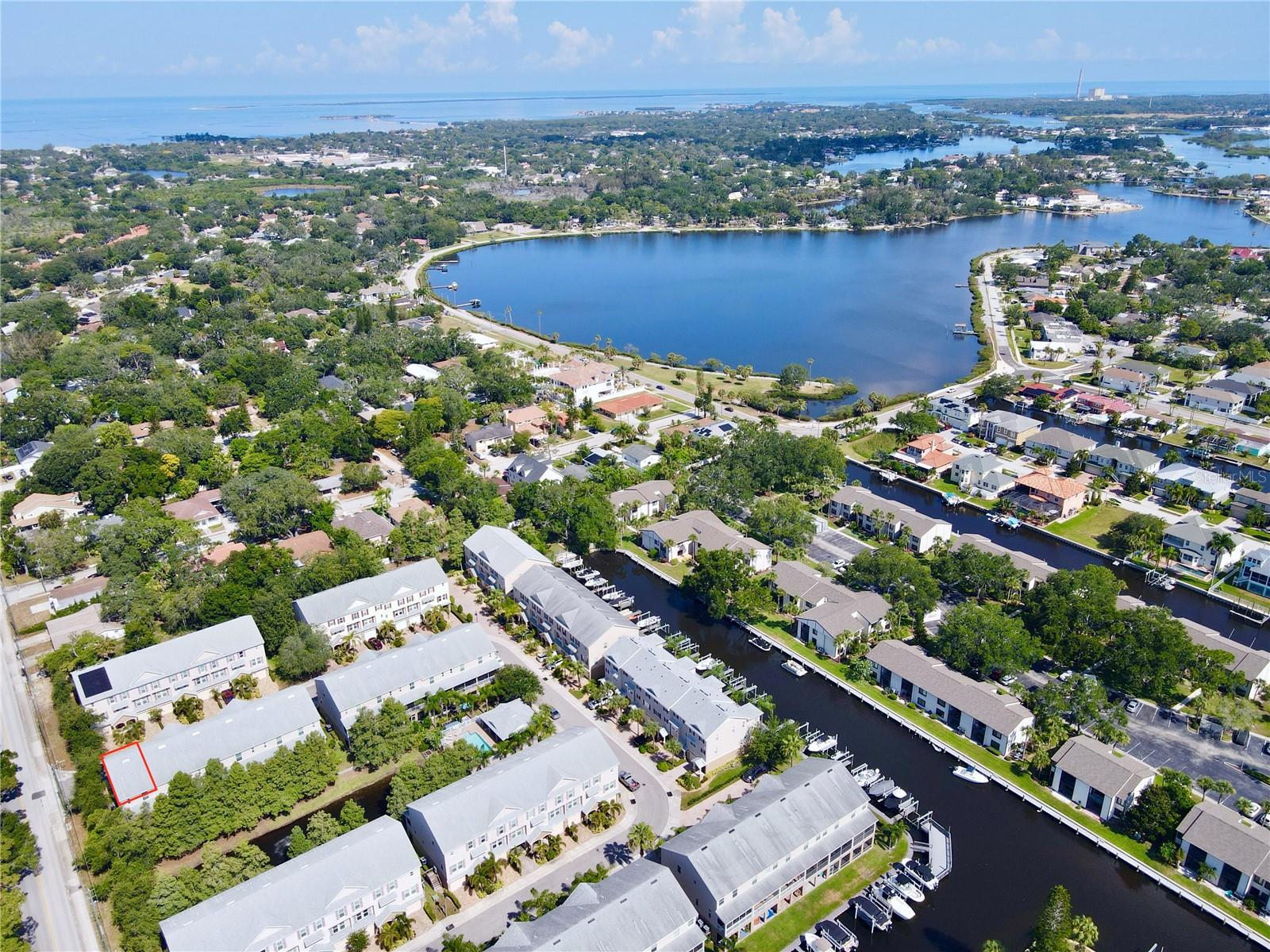 Experience the ultimate maintenance-free coastal lifestyle in the highly sought-after gated waterfront community of Callista Cay in Tarpon Springs. One of the few townhomes in the area with no history of flooding during any hurricanes, this beautifully maintained end-unit also includes an assumable flood insurance policy, approximately $610 annually, providing added peace of mind and potential savings. Built in 2020, this spacious three-story home features 3 bedrooms, 2.5 bathrooms, and 1,828 square feet of thoughtfully designed living space.

The oversized two-car garage includes an 8-foot-tall door to accommodate larger vehicles with extra space for golf carts, water toys, or a boat trailer, along with upper storage racks and additional under-stair storage. The home is also future-ready with room in the garage for a potential elevator installation.

The main living level offers an open-concept design ideal for entertaining. The chef's kitchen features solid wood soft-close cabinetry, quartz countertops, stainless steel appliances, an induction stove, and an extended center island with breakfast bar seating. A convenient half bath is located just off the kitchen, perfect for guests. The spacious living area opens to a screened balcony overlooking tranquil cypress trees and a peaceful pond, creating the perfect space for coffee in the morning or relaxing in the evening.

Upstairs, the primary suite includes tray ceilings, a cozy alcove, an extended walk-in closet, and a newly remodeled en-suite bathroom (February 2025) featuring dual vanities and a linen closet. Two additional bedrooms share a Jack-and-Jill bathroom, while the upstairs laundry room offers added shelving and storage.

This beautifully maintained end-unit townhome offers added privacy, abundant natural light from extra windows, and the peace of mind of an elevated interior location with no history of flooding during any hurricanes. Additional features include fire suppression sprinklers and an elevation certificate.

Designed for boating enthusiasts, Callista Cay offers direct canal access to the Gulf. Multiple community boat slips are available for lease or purchase (subject to availability), and the seller is willing to assist the buyer in navigating the lease or purchase process.

Callista Cay offers a low-maintenance lifestyle with a gated entrance, community pool, clubhouse, and beautifully maintained grounds. Ideally located just minutes from the historic Sponge Docks, Fred Howard Park, Sunset Beach, local marinas, the Pinellas Trail, waterfront dining, antique and boutique shopping, and downtown Tarpon Springs, this exceptional end-unit combines the best of Florida's boating lifestyle with the security and peace of mind of an elevated interior location.