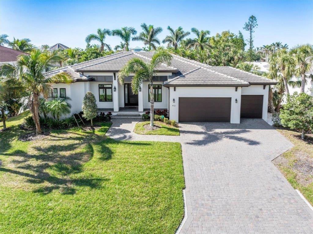 Under contract-accepting backup offers. Stunning value for newer build Garden Home on Bird Key! Welcome to Bird Key, Sarasota’s premier island neighborhood perfectly nestled between the heartbeat of downtown Sarasota and the allure of St. Armands Circle. This newer custom-built residence combines elevated design with impact-rated windows as well as newer construction and thoughtful upgrades throughout. Step inside and be captivated by the open great room, which features wide-plank hardwood flooring, tray ceilings with wood beams, custom wall treatments, and automated blinds. The chef’s kitchen is crafted with quartz counters, Bosch stainless steel appliances, a center island with bar seating, walk-in pantry, and a beautifully tiled backsplash.

The primary suite is a private sanctuary with direct pool access, dual custom walk-in closets, and a spa-inspired bath with a free-standing soaking tub and dual-entry shower. Guests are treated to two additional stylish en-suite bedrooms, while the versatile fourth bedroom is currently used as a office.

Enjoy entertaining in the lush outdoor backyard space, which includes a heated saltwater pool and spa with LED lighting, pavered deck, wood-accent ceiling, and a full summer kitchen with refrigeration and a plumbed-in gas grill. Additional features include a concrete tile roof, tankless gas water heater, irrigation system, custom exterior trim work, and a 3-car garage. Lightly lived in as a seasonal retreat, this home is available with an optional furniture package for effortless move-in.

Bird Key living comes with the option to join the Bird Key Yacht Club for an additional fee.  The club is currently being rebuilt into a beautiful state-of-the-art facility — just moments from your doorstep.

This is more than a home – it’s the Bird Key lifestyle. Schedule your private showing today and claim your place in one of Sarasota’s most coveted addresses.