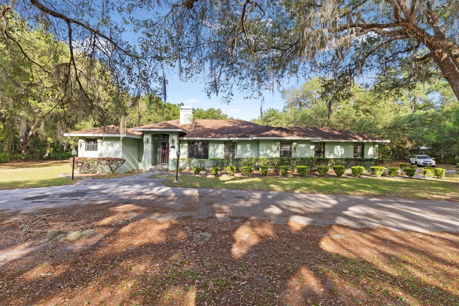 Tucked away in the heart of Wildwood, this rare 3-acre property offers the perfect blend of space, privacy, and convenience. This 4-bedroom, 2-bath home spans 2,133 square feet and features a two-car garage, with a roof replaced in 2016 for added peace of mind. Surrounded by majestic oak trees that provide shade and a truly peaceful setting, the property feels like your own private retreat. Yet, it’s centrally located just minutes from The Villages, giving you quick access to shopping, dining, entertainment, and nearby schools. The home itself offers solid bones and a spacious layout, making it a great opportunity for buyers looking to add their personal touch. While it could use some updates, it’s priced to sell and ready for someone to make it their own. Properties with this much land in such a prime location don’t come along often. If you’ve been searching for space, location, and opportunity all in one, this property is one you don’t want to miss.