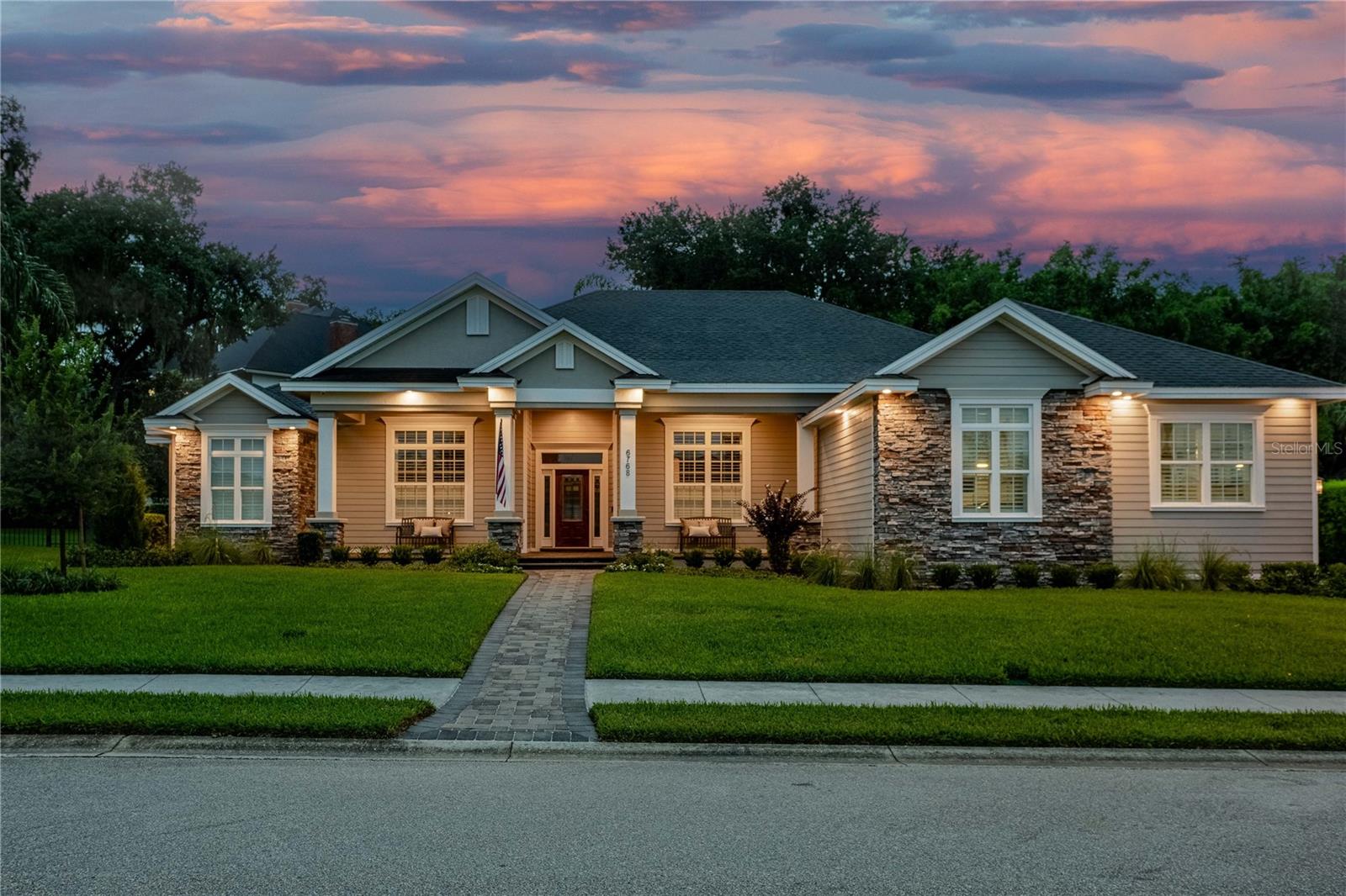 This meticuliously maintained 5-bedroom, 3.5-bath home boasts 4120 sf of elegant yet comfortable living space and 6121 sf under roof.  This spacious and exceptional home creates the perfect space for indoor and outdoor living and entertaining. This thoughtfully designed floor plan features formal living and dining rooms, an oversized family room, spacious bonus room, gorgeous hardwood floors, and an updated open-concept kitchen complete with numerous new and updated Stainless appliances and a hidden walk in pantry.  The large bonus room with a full bar, sink, and icemaker is the perfect space for entertaining, game nights, or a media room. Step outside to your private backyard oasis featuring a screened lanai, saltwater pool with sun ledge, outdoor kitchen with built in gas grill, beautifully landscaped yard, and fire pit with inviting seating area, lights and decorative wall—ideal for enjoying Florida living year-round.  Additional features include magnificent wood work- shiplap, built in cabinetry, tray and coffered ceilings, and crown molding in many rooms in addition to 7 inch crown and trim molding throughout the home. Also, 2 / 240 amp service panels, neighborhood propane gas, new tankless water heater, new Rheem gas pool heater, hook up for generator, hard wired security cameras, built in surround sound speakers inside and out, newly acid washed pebble-tec finish in the salt-water pool, and so much more!    

With generous living spaces, quality updates, and resort-style outdoor amenities, this exceptional home offers the perfect combination of comfort, functionality, and style. Don't miss the opportunity to make this incredible property your next home!