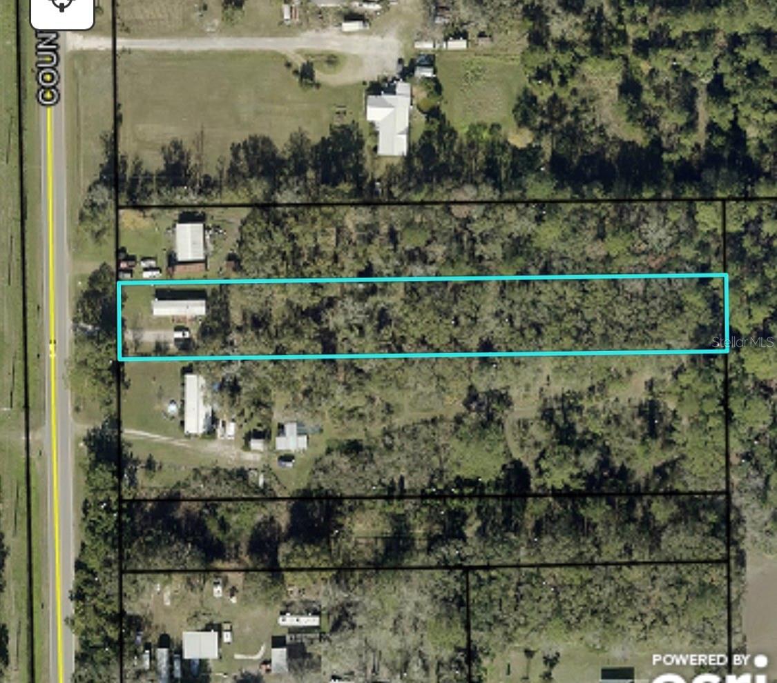 Opportunity awaits! This 2-bedroom, 1-bath mobile home is situated on 1.08 acres in Bunnell with paved road frontage on County Road 305. The property features a very deep lot with plenty of room to spread out, offering privacy, flexibility, and endless possibilities for future use.
The home could benefit from updates and improvements, making it an excellent opportunity for investors, handymen, or buyers looking to build equity while enjoying affordable country living. With a private well, you’ll enjoy the convenience of no water bill.  Affordable properties with acreage are becoming increasingly difficult to find, especially at this price point. The property’s impressive depth creates exciting opportunities for future growth and expansion, while the generous lot size provides ample room for gardening, outdoor living, storage, recreation, and more. Whether you’re looking for a peaceful retreat or an investment with potential, this property offers a rare combination of value and possibilities.  Priced at just $99,000, this may be one of the best opportunities to own over an acre of land in Flagler County. Bring your vision and make this property your own!