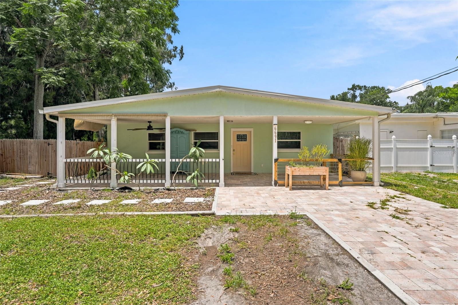 Tucked at the end of a quiet dead-end street—so private that if you didn't live here, you'd never know it existed—this updated and chic ranch-style home offers the rare combination of seclusion and easy St. Petersburg living.
Step inside to a bright living area wrapped in windows that flood the space with natural light. The kitchen is the heart of the home, featuring white cabinetry with brass finishes, quartz countertops, stainless steel appliances, and an open dining space made for gathering. Just off the kitchen, an indoor laundry and storage room adds everyday function.
A smart split floor plan delivers both privacy and flow. The primary suite sits off the kitchen and features a sloped ceiling, walk-in closet, ensuite bathroom, and sliding doors opening to the backyard deck. On the opposite side, two secondary bedrooms—each with spacious closets—share a full bathroom, ideal for family, guests, or a home office.
Outside, the front offers a driveway, carport, and large patio, while the fully fenced backyard is private and spacious, with a deck accessible from both the kitchen and primary bedroom.
Move-in ready, low-maintenance, and quietly tucked away—this one checks the boxes that matter. Schedule your private showing today.