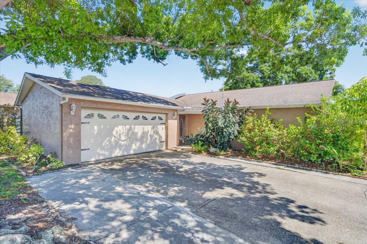 Move-in ready and offering plenty of flexible living space, this 4-bedroom, 3-bath Pool home is ready for its next owner. The spacious family room is the heart of the home, featuring vaulted ceilings and an open layout that's perfect for everyday living and entertaining. A separate living room provides additional space for relaxing, working from home, or gathering with guests. The generously sized primary suite includes sliding glass doors leading directly to the backyard and pool. Three additional bedrooms including a possible second primary bedroom. Situated on a corner lot, the home also offers convenient access to US Hwy. 19, making commuting and everyday errands a breeze. With a functional floor plan, inviting living areas, and a large, fully fenced backyard with a sparkling, and designed for enjoying Florida's sunshine, this home is one you won't want to miss! This has 2 possible Master suites.