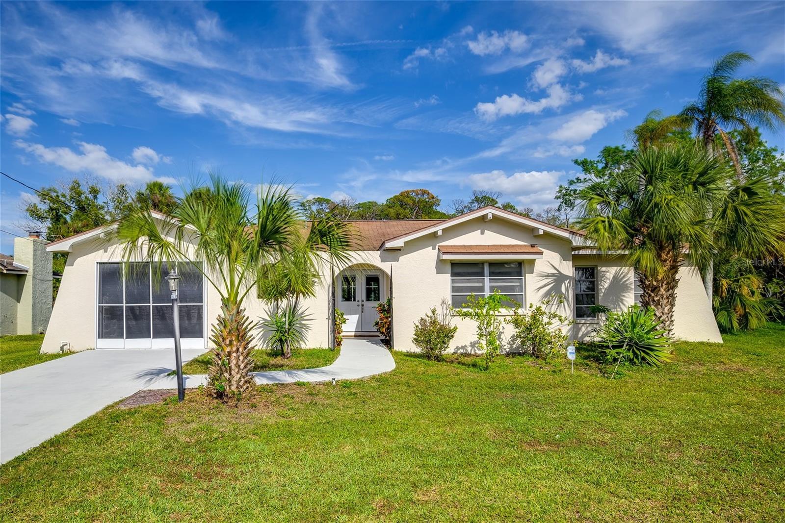 Welcome home! This beautifully maintained property features a renovated kitchen with new appliances, quartz countertops, soft closed cabinets, and a convenient quartz breakfast bar. The dining area flows seamlessly into the family room and living room-perfect for entertaining. Both full bathrooms have also been tastefully renovated, offering modern comfort and style throughout.
Step outside to relax and unwind in your screened-in pool or soak in the peaceful canal views from your spacious 1/4+ acre lot with a seawall. 
Ideally located just minutes from parks, beaches, schools and shopping.
Love fishing, boating or kayaking? Embrace the outdoor lifestyle and experience Florida living at its finest.  This home will  make an excellent investment property ideal for short-term, long-term leasing, or Airbnb potential. Don't miss it!