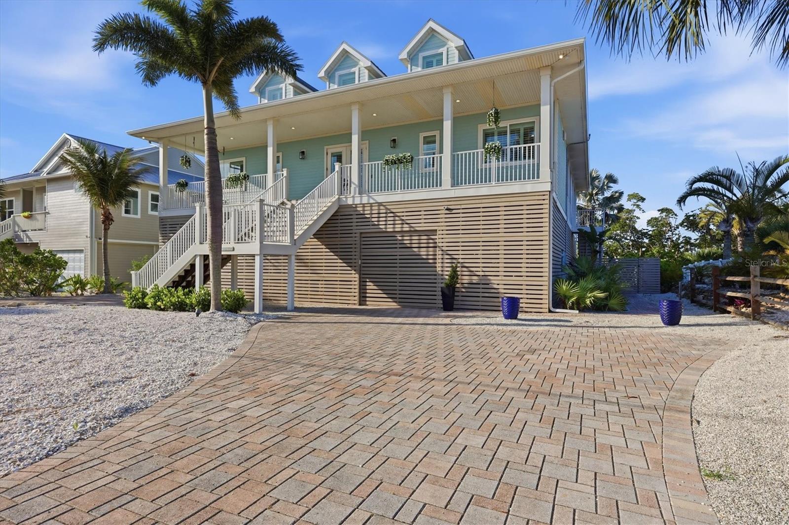 Old Florida coastal charm meets laid-back island living in this beautifully furnished 3 bedroom, 3 full bath, 2 half bath waterfront home with a loft and bunk area, located on the pristine sanctuary of Palm Island. Enjoy sweeping views of the Bocilla Waterway, along with direct boating access via one bridge to the Intracoastal Waterway and Gulf in just minutes from your private dock and boat lift.
Inside, the light and airy floor plan was designed to embrace coastal living with soaring ceilings, walls of windows, architectural details throughout, and seamless indoor-outdoor spaces. The stunning kitchen is perfect for gathering and entertaining, featuring a massive island with prep sink and seating, granite countertops, solid wood cabinetry, Sub-Zero and Wolf appliances, wine fridge, and a large walk-in pantry. The open living and dining areas center around a cozy wood-burning fireplace and flow effortlessly to the screened waterfront lanai.
The spacious waterfront primary suite is located on the main level, while guests enjoy their own private suite on the opposite side of the home. Upstairs offers even more room to spread out with a large family room and wet bar, an additional guest suite, loft space, bunk area, and another powder bath—creating the perfect setup for hosting family and friends.
Outside, the tropical setting is pure paradise with mature landscaping, a saltwater pool, huge sunny lounging deck, shaded entertaining space, outdoor shower, tons of storage, a golf cart garage, and multi-car pavered carport. Spend your evenings enjoying incredible sunset views over the Bocilla Waterway after a day of boating, fishing, shelling, or relaxing at the beach.
Additional upgrades include a 38.88 kW whole-house solar photovoltaic system, 24,000-watt Generac generator, and two large propane tanks for efficiency and peace of mind. Accessible only by car ferry (only a 3 minute ride), Don Pedro Island and Palm Island offer a rare escape from the crowds with quiet beaches, world-class fishing, and the relaxed island lifestyle that makes this stretch of Florida’s coast so special.
