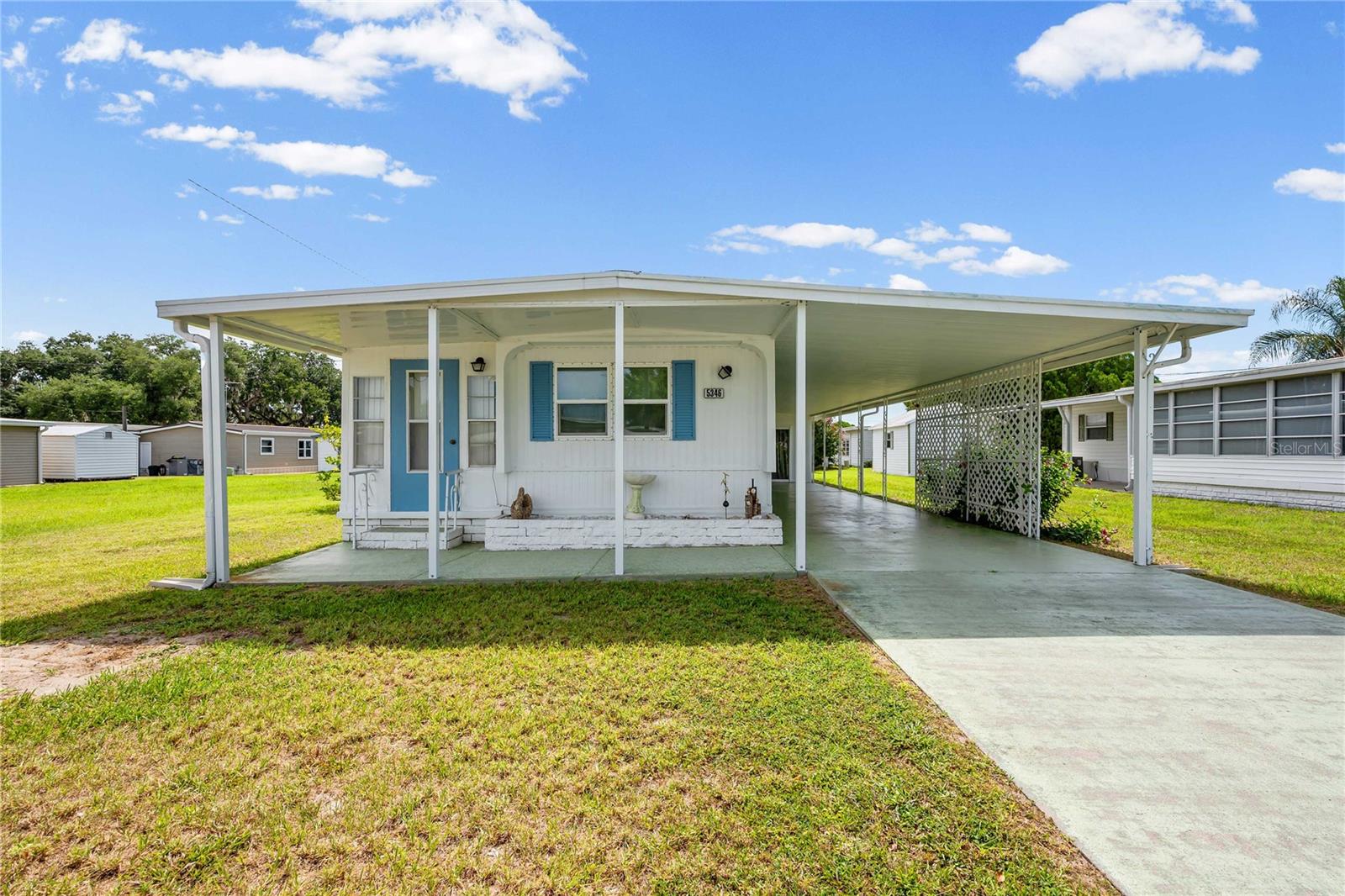 Perfect for seasonal or year-round living in sunny Florida, this inviting 2-bedroom, 2-bathroom home is located in the desirable Betmar Acres active 55+ golf community, where you own the land and enjoy a low annual community fee of just $448. Designed for comfortable living, the home features a desirable split-bedroom floor plan and an open-concept layout between the kitchen and living room, creating a bright and welcoming atmosphere. A versatile bonus room offers endless possibilities and could serve as a third bedroom, craft room, hobby space, or home office. Outside, you'll find exceptional storage and workspace options, including a large carport and spacious attached laundry area with plenty of room for tools, seasonal decorations, and more. An attached rear shed provides convenient golf cart storage, while the detached 9x11 shed with electricity is perfect for a workshop, hobby area, or additional storage. Important updates completed in 2023 include a new membrane roof, double-pane windows, and central air conditioning, offering added value and peace of mind. Betmar Acres residents enjoy an active lifestyle with outstanding amenities, including 27 holes of golf, swimming pools, hot tubs, clubhouses, pickleball and tennis courts, shuffleboard, walking paths, and a full calendar of social activities. Conveniently located near shopping, restaurants, premier medical facilities, and just a short drive to some of Florida's most beautiful Gulf Coast beaches. Schedule your private showing today and discover all the amenities and activities this vibrant community has to provide!
