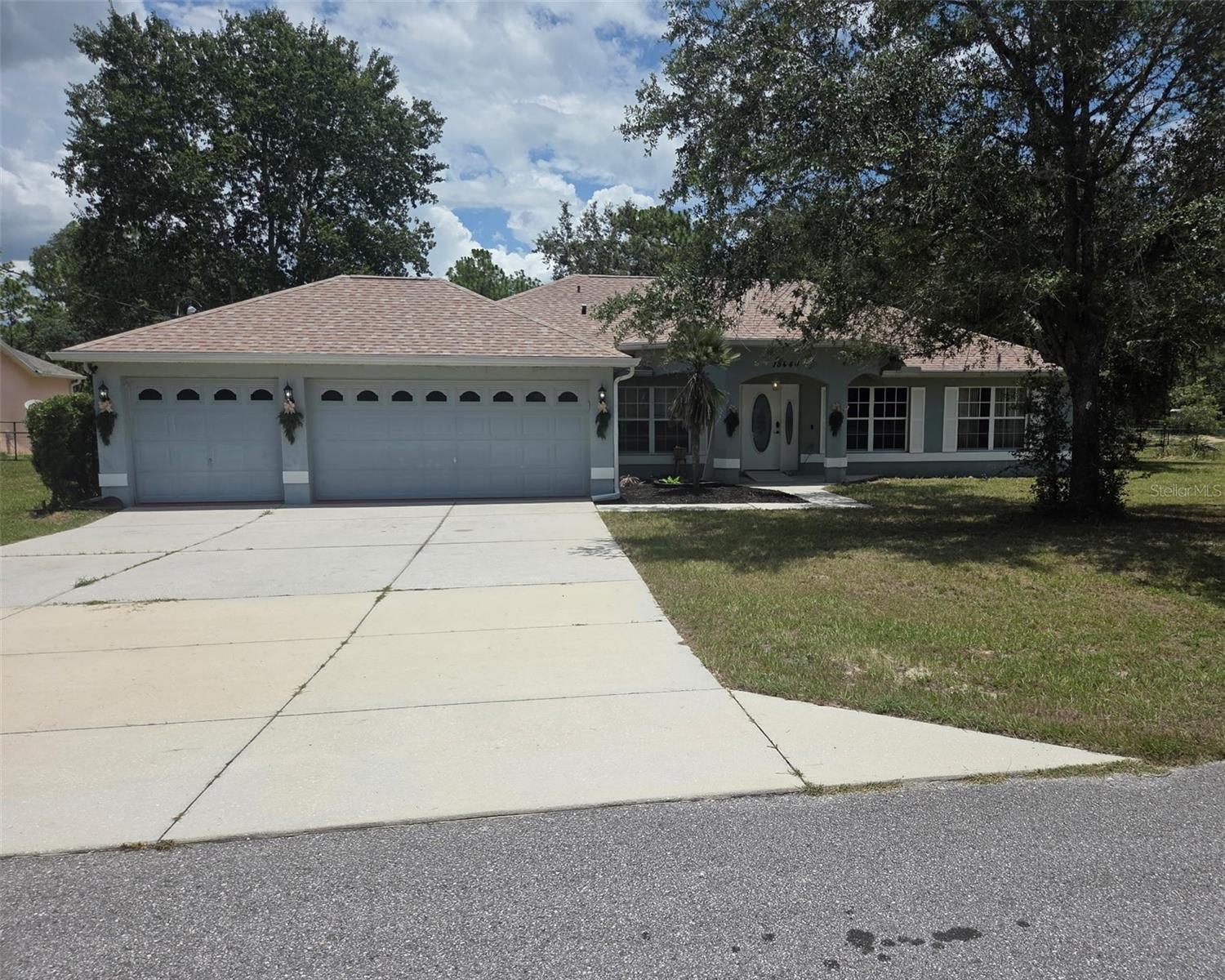Opportunity is Knocking!! Take a look at this Custom-Built Heartland Home sits on 0.9 Acres. This property offers an Fenced in Yard.  Inside boasts a split bedroom, open floor plan with living and dining rooms. 14ft vaulted ceilings, crown molding, beautiful laminate floors. and granite counters throughout. Upgraded kitchen features double pantries, wood cabinets, stainless steel appliances, with breakfast bar and a sizable nook. Private master Suite has a his-n-hers walk in closets, Primary bath has a dual Vanity and step-in -shower.  There is a open patio which is great for your grill. In Addition to the attached 3 car garage, there is a 1000 +sq. ft detached garage/workshop with twin roll up doors. Building is wired 220 volts with a separate studio apartment  with 1 bedroom and 1 bath built in 2010. There is a covered carport,. RV Pad is built for an oversized unit with water and 30 amp electric with 3 additional plugs.  Septic and Well with filtration and Conditioning systems and A/C.  Home has new roof 03/26, new A/C 2025. Double gates on both sides of home for easy access. Also has an extra wide driveway. No Flood Zone, No HOA.  Many Opportunities!!  MUST SEE!!!