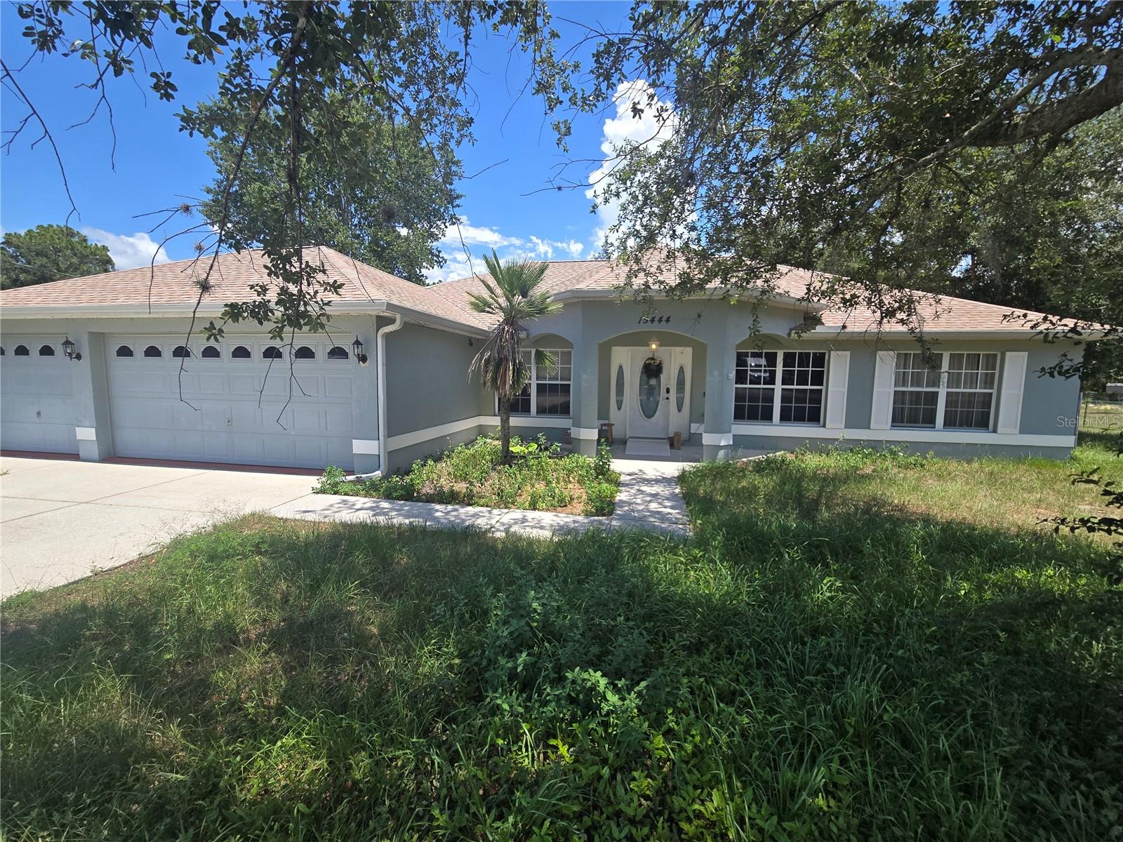 Opportunity is Knocking!! Take a look at this Custom-Built Heartland Home sits on 0.9 Acres. This property offers an Fenced in Yard.  Inside boasts a split bedroom, open floor plan with living and dining rooms. 14ft vaulted ceilings, crown molding, beautiful laminate floors. and granite counters throughout. Upgraded kitchen features double pantries, wood cabinets, stainless steel appliances, with breakfast bar and a sizable nook. Private master Suite has a his-n-hers walk in closets, Primary bath has a dual Vanity and step-in -shower.  There is a open patio which is great for your grill. In Addition to the attached 3 car garage, there is a 1000 +sq. ft detached garage/workshop with twin roll up doors. Building is wired 220 volts with a separate studio apartment  with 1 bedroom and 1 bath built in 2010. There is a covered carport,. RV Pad is built for an oversized unit with water and 30 amp electric with 3 additional plugs.  Septic and Well with filtration and Conditioning systems and A/C.  Home has new roof 03/26, new A/C 2025. Double gates on both sides of home for easy access. Also has an extra wide driveway. No Flood Zone, No HOA.