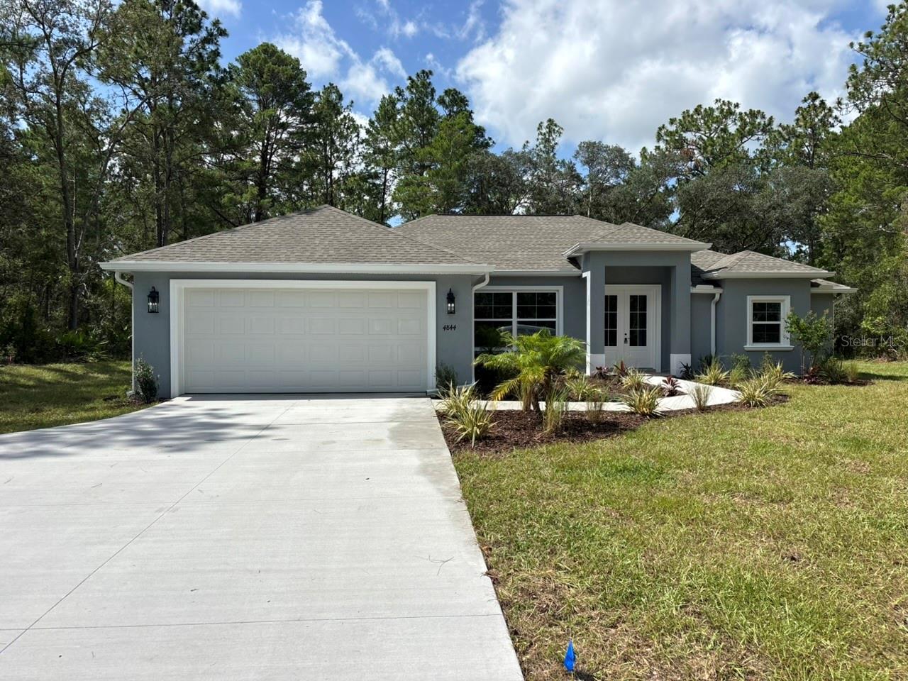 NEW CONSTRUCTION. Move-in-ready 2026 Perdido model featuring 3 bedrooms, 2 bathrooms, 2,056 square feet, and a private saltwater pool on a full one-acre homesite in Pine Ridge. This concrete-block home features a 30-year architectural shingle roof, energy-efficient double-pane windows, rain gutters, and a 10-year structural warranty. Located in Flood Zone X, the property is considered high and dry, with no flood insurance required.

French doors open to a spacious split-bedroom floor plan with high ceilings, luxury vinyl and tile flooring, and abundant closet space. The kitchen features granite countertops, an oversized island with extensive storage, subway tile backsplash, pot filler, large two-door pantry, and a breakfast nook. Tray ceilings with crown molding and recessed lighting highlight both the living room and primary suite. The primary bedroom includes two walk-in closets, while the en-suite bath offers dual vanities, a private water closet, garden tub, and oversized walk-in shower with dual shower heads. The exceptionally large laundry room includes extensive cabinetry, opposing washer and dryer connections, a utility sink, and granite folding counters.

A large sliding door opens to the screened outdoor living area and 12-by-24-foot in-ground saltwater pool with LED lighting. The two-door screen enclosure, basic pool-cleaning equipment, and three-year pool-equipment warranty are included. Additional features include irrigation, attractive landscaping, covered front and rear porches, an attached two-car garage with side access, an expanded driveway, and extra guest parking.

Pine Ridge offers a community center, dog park, playground, tennis and pickleball courts, equestrian facilities, and miles of riding and walking trails. Low annual HOA fee and no CDD.
