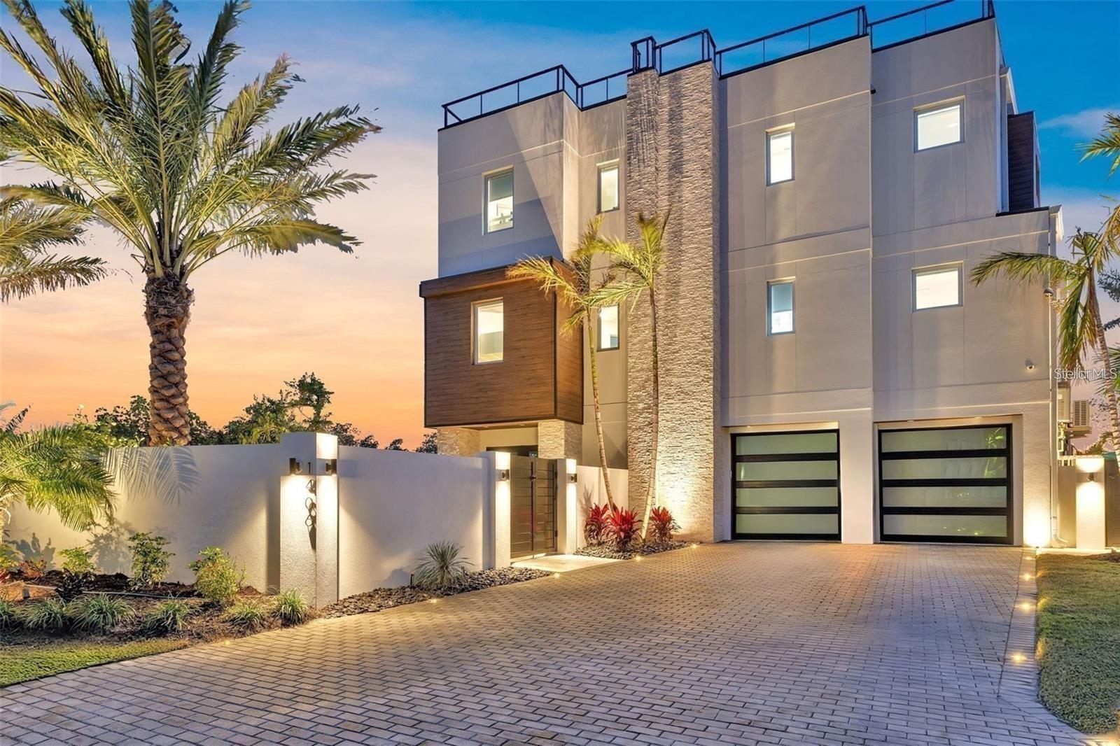Under contract-accepting backup offers. Welcome to 1406 Tangier Way, a breathtaking expression of coastal contemporary luxury in San Remo Estates in Sarasota, where architectural excellence meets waterfront serenity. This 3,294 sq. ft. home is a seamless blend of sophistication, innovation, and artisanal craftsmanship, offering four bedrooms, three full baths, and unparalleled views of Sarasota Bay.

Every detail has been meticulously curated, from the custom Doca cabinetry, hand-crafted and imported from Spain, to the high-grade Portuguese porcelain countertops that extend from the kitchen to the ceiling, creating a striking visual statement. The gourmet kitchen is equipped with state-of-the-art Fulgor Milano appliances, an oversized island, and bespoke finishes, setting the stage for an elevated culinary experience. Walls of strategically placed windows flood the interiors with natural light, enhancing the contemporary loft-inspired aesthetic while showcasing the property’s unrivaled water views. The second-floor master suite is a sanctuary of refined elegance, featuring a private office, floor-to-ceiling water views, and a spa-inspired en-suite bath adorned with intricate, high-end tilework, exuding a sense of tranquility and indulgence.

Ascend to the rooftop terrace, where artificial turf, a wet bar, and panoramic views create an unforgettable setting for sunset soirees and intimate gatherings under the stars. The outdoor living space is nothing short of an oasis, boasting leather-marble walkways, a champagne spa, a gas fireplace, and a fully equipped outdoor kitchen, designed for seamless alfresco entertaining. An automated mosquito misting system ensures year-round comfort, while Control4 smart home technology integrates lighting, climate, security, and entertainment at the touch of a button, delivering an effortlessly luxurious lifestyle. Boaters will revel in the two newly constructed boat lifts and direct access to Sarasota Bay, making this home an extraordinary retreat for waterfront living at its finest.

Built with strength, timeless beauty, and the highest level of craftsmanship, this extraordinary waterfront residence is truly a rare find—a once-in-a-lifetime opportunity to own an unparalleled slice of Sarasota’s coastal paradise. Schedule your private showing today—this exclusive sanctuary could be yours.