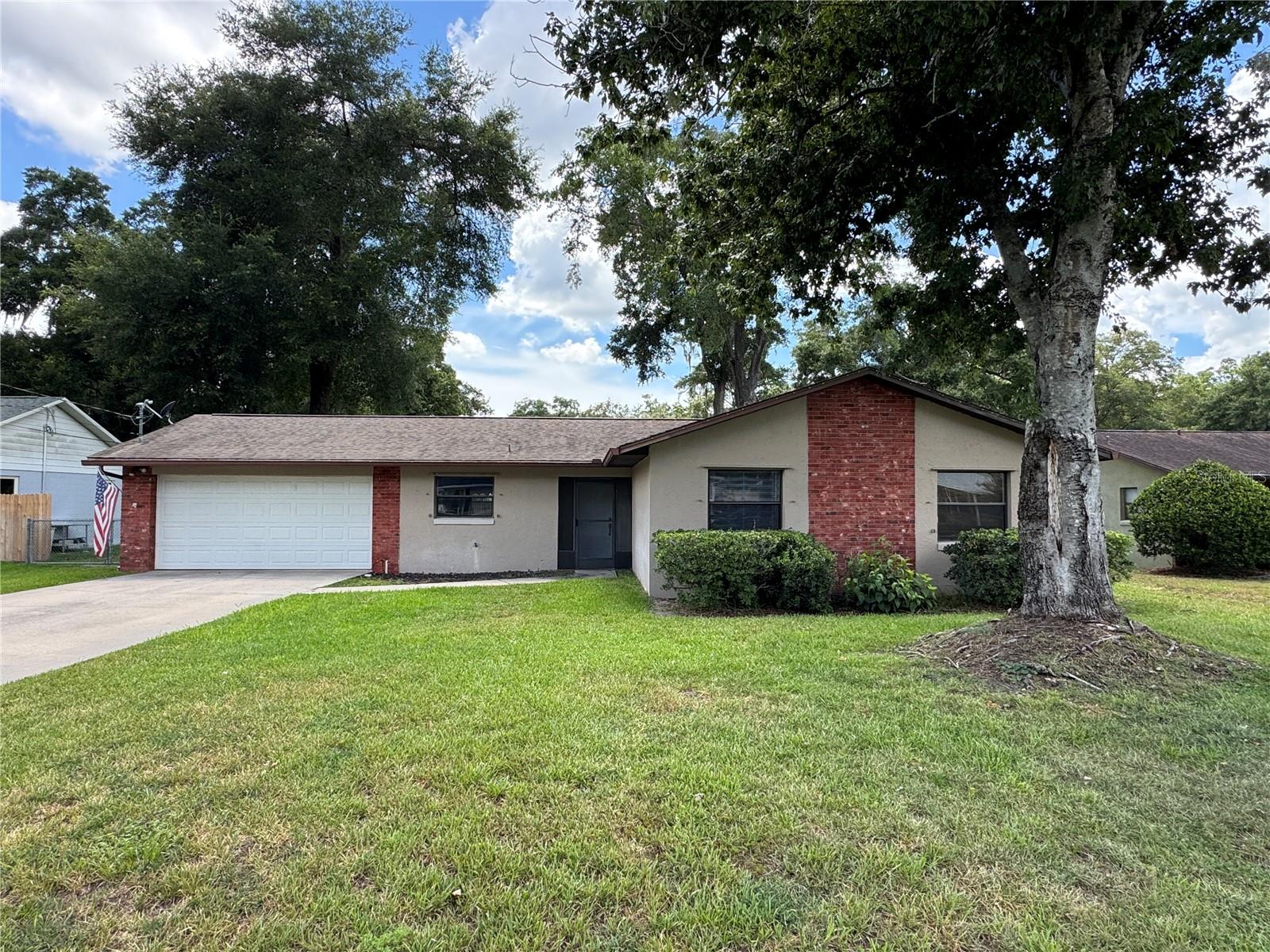This well-maintained home offers a welcoming blend of style, comfort, and thoughtful upgrades throughout. Inside, you’ll find wood plank flooring and ceramic tile in most areas, complemented by custom lighting in the common spaces and ceiling fans that enhance both ambiance and efficiency. The kitchen features a nice backsplash, all appliances convey, and the home includes blinds and window treatments for a finished, move-in-ready feel. The lanai is fully screened, creating a perfect spot for relaxing or entertaining. The home has been re-insulated in the attic, includes a water softener, and offers peace of mind with septic drainfields cleared in 2021. The irrigation system runs on a well, keeping the landscaping lush without added utility costs.  Out back, enjoy a large fenced yard that provides excellent privacy, surrounded by mature trees and established landscaping that create a serene outdoor retreat.
This property combines modern updates, practical improvements, and inviting outdoor space—an ideal place to call home.