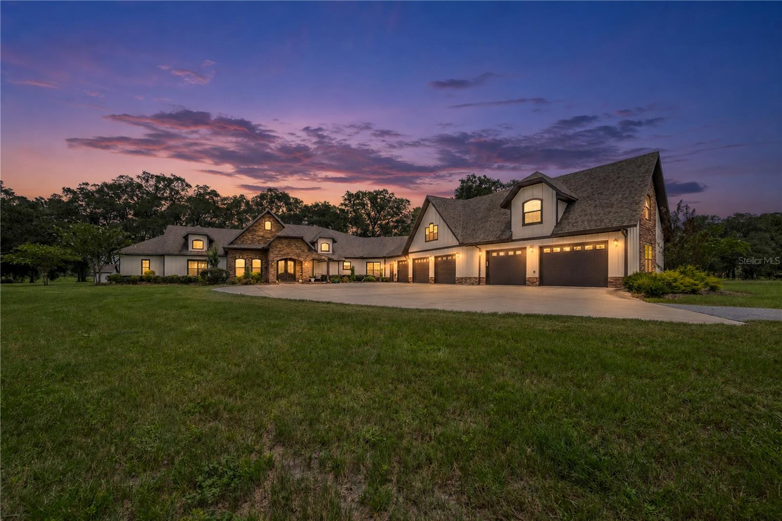 Welcome to your dream country estate in the heart of Newberry, Florida. Nestled on 32 picturesque acres within the city limits, this exceptional property offers the perfect blend of luxury, privacy, and country living. From the expansive pastures to the thoughtfully designed home and impressive outdoor amenities, every detail has been crafted to create an extraordinary lifestyle. Step through the grand entrance into a warm and inviting living space centered around a beautiful gas fireplace, creating the perfect setting for relaxing evenings or entertaining family and friends. The open-concept floor plan flows effortlessly into the dining area and gourmet kitchen, where custom cherry cabinetry, granite countertops, premium appliances, and rich hickory flooring combine timeless elegance with everyday functionality. The home features 4 spacious bedrooms and 4.5 luxurious bathrooms, providing plenty of room for family and guests. The owner's suite serves as a private retreat with a spa-inspired bathroom featuring a soaking tub, travertine walk-in shower, and a generous walk-in closet. Large windows throughout the home showcase peaceful views of the surrounding acreage. An oversized attached garage offers abundant space for vehicles, recreational equipment, and storage. Outdoors, the property is equally impressive. Enjoy your own fenced-in swimming pool complete with a beautiful waterfall feature, creating the perfect place to cool off, entertain, or unwind while overlooking the scenic countryside. The sprawling acreage includes expansive pastures ideal for horses, livestock, or simply enjoying the beauty and privacy of rural North Florida. A massive 6,000-square-foot barn provides exceptional space for hay storage, equipment, farm operations, or a variety of other uses. While you'll enjoy the peace and tranquility of country living, you'll also appreciate the convenience of being located within the city limits of Newberry and just a short drive to Gainesville. Nearby you'll find the University of Florida, UF Health Shands Hospital, shopping, dining, and countless recreational opportunities. This remarkable 32-acre estate offers a rare opportunity to own a luxurious country property with outstanding amenities, including a resort-style pool, expansive barn, and beautiful pastureland—all in one of North Central Florida's most desirable locations. Schedule your private showing today and experience everything this exceptional property has to offer.