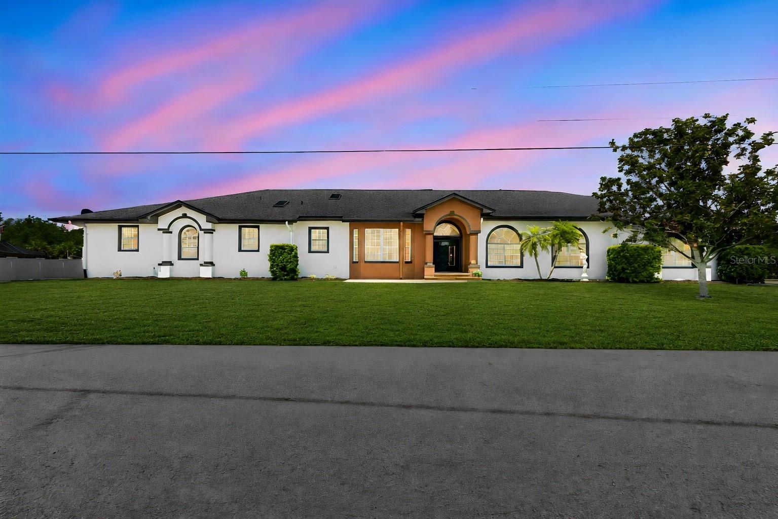 Virtually Staged. luxury living with a modern edge in this one-of-a-kind custom-built 4-bedroom, 3-bathroom waterfront home. Designed with exceptional craftsmanship and attention to detail, this stunning residence offers the perfect blend of elegance, comfort, and functionality.

Situated on an oversized lot with approximately 200 feet of canal frontage, this exceptional property offers breathtaking water views and endless opportunities for boating, fishing, kayaking, paddleboarding, or simply enjoying the peaceful surroundings. Nature lovers will appreciate the incredible wildlife right from their own backyard, where it's common to see dolphins, manatees, turtles, alligators, and jumping fish in their natural habitat.
Step outside to your own private resort-style oasis featuring an impressive 50-foot lap pool with an attached spa, surrounded by expansive outdoor living and entertaining areas designed for relaxing, hosting family and friends, or taking in spectacular waterfront sunsets.
Inside, the thoughtfully designed open-concept floor plan showcases spacious living areas, upscale finishes, and modern architectural details throughout. The luxurious primary suite, generously sized guest bedrooms, and beautifully appointed bathrooms provide comfort and style for everyday living.
This property also offers exceptional space for all your vehicles and toys with an oversized two-car garage and a dedicated RV/trailer parking pad. Best of all, there is no HOA, giving you the freedom to enjoy your property without unnecessary restrictions.