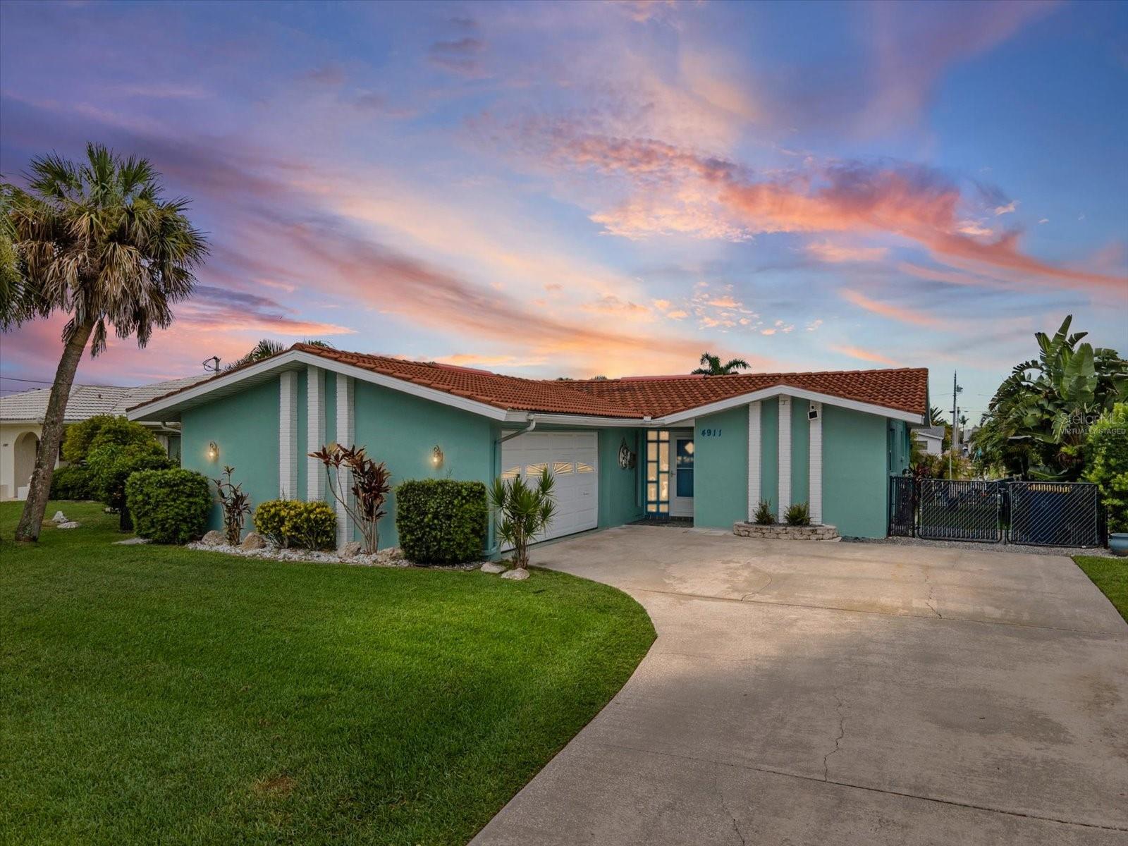Virtually Staged. WATERFRONT PARADISE IN NEW PORT RICHEY! This stunning, fully renovated 2BR/2BA coastal oasis offers direct, unrestricted access to the Gulf of Mexico with absolutely NO BRIDGES. Meticulously upgraded throughout, featuring a high-quality remodel completed April 2025 for absolute peace of mind. Chef's kitchen features brand-new cabinetry, gleaming granite countertops, modern pendant lighting, new appliances & garbage disposal. Elegant 100% waterproof luxury vinyl plank flooring flows uniformly throughout.  Textured ceilings are stunning, stone-walled foyer, cedar-lined coat closet, & gorgeous plantation shutters on all windows. Expanded master suite bathroom boasts custom pocket doors, double sinks, & walk-in closet with built-ins next to a stone-floor shower. Step outside through the Hurricane-proof sliding glass doors that pocket completely into the wall and have premium electric shades, onto a covered ceramic-tile lanai & massive paver deck surrounding an upgraded saltwater pool (2022) with PebbleTec coating, sun shelf, fountain, auto-overflow & new motor. Enjoy incredible Florida sunsets from your desirable west-facing backyard.  Boater's dream setup: 10ft wide seawall, and 3 expansive docks measuring 11.5x12.9x17.1, 12.5x7.8x11.5, and 19.2x1.6. outdoor shower, pergola & dual boat lifts (10k lbs & 8k lbs). All flooding remediation complete with full permits, new HVAC (2025), & upgraded exterior electrical. Home includes clear hurricane shutters that are easily attached, if needed.  You'll also enjoy the oversized 2 car garage. Welcome home!