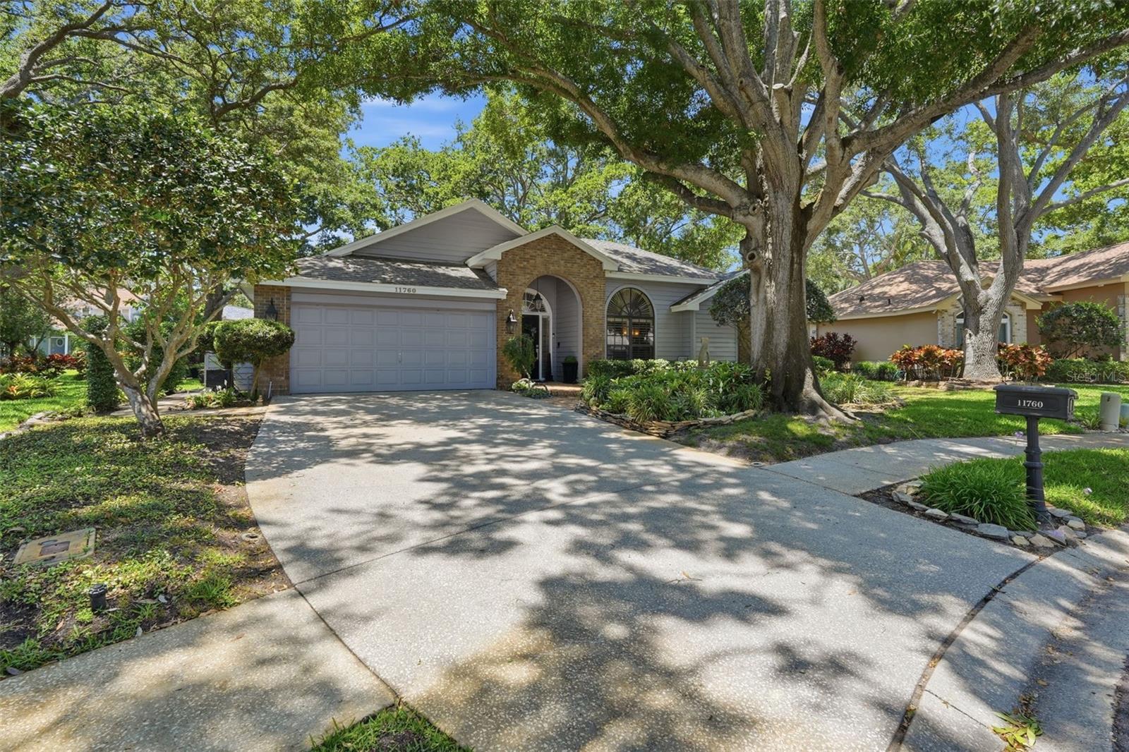Words and pictures truly cannot do this spectacular property justice. From the moment you arrive, nestled on a private, oak-canopied cul-de-sac in the charming community of Quail Ridge, you are enveloped in pure serenity. This is a home that feels like a peaceful sanctuary—yet it sits just ten minutes from the sun-kissed Gulf beaches and steps from the scenic Pinellas Trail. Best of all, you can enjoy this paradise with total peace of mind, as the property sits securely in a non-flood zone. A true masterpiece of design, the home welcomes you with striking architectural details, elegant crown molding, custom wood shutters, and luxury vinyl flooring that flows effortlessly throughout. With over 2,250 square feet of sunlit, open-concept living space, the interior is perfectly designed for creating lifelong memories. Imagine cozy evenings by the fireplace, hosting family gatherings in the formal living and dining spaces, or preparing meals in the beautifully upgraded kitchen, complete with quartz countertops and premium new appliances. When you need to unwind, the private primary retreat offers a luxurious escape with a custom walk-in closet and a spa-like bath. Three additional spacious bedrooms ensure comfort for family and guests. Step outside into your own spectacular outdoor paradise. The grounds are designed for relaxation and entertainment, featuring a sprawling brick lanai, a tranquil sculpture garden, and a six-seater digital therapeutic spa made for stargazing. Complete with a large, parklike side yard just waiting for a future pool, this isn't just a house—it is the backdrop for your beautiful next chapter.