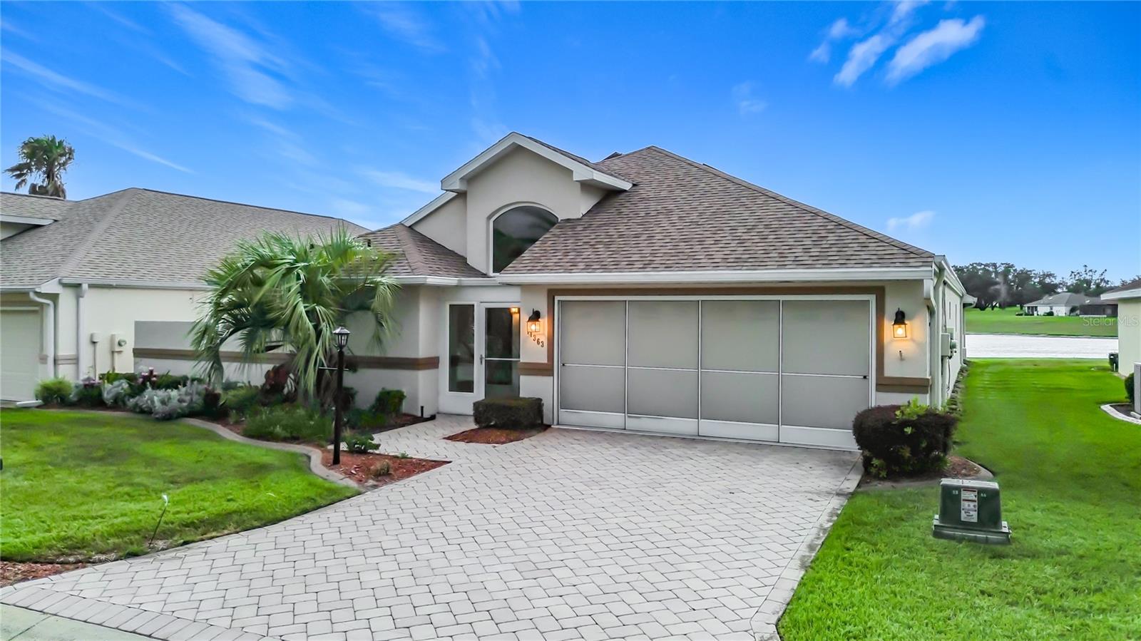 Experience breathtaking lakefront living in Stonecrest, one of Central Florida's premier 55+ gated golf course communities, conveniently located just minutes from The Villages. With no CDD fees and no bond, this beautifully maintained concrete block home offers the perfect blend of comfort, space, and spectacular views.
Featuring 3 bedrooms, 3 full bathrooms, a 2-car garage, and an impressive 2,637 square feet of living space, this thoughtfully designed split-bedroom floor plan provides privacy for both homeowners and guests. From the moment you arrive, you'll appreciate the attractive paver driveway, recently painted exterior, and pride of ownership throughout.
The updated kitchen is designed to impress with granite countertops, stainless steel appliances, soft-close cabinetry, pull-out shelving, and abundant workspace, making it ideal for everyday living and entertaining. The spacious great room flows seamlessly into the expansive 20' x 15' Florida room, where walls of windows frame panoramic lake views and unforgettable Florida sunsets.
Step outside to enjoy the 15' x 10' screened lanai or relax on the open patio beneath the pergola while taking in the peaceful waterfront setting. The generous primary suite offers a large walk-in closet with adjustable shelving and an updated en-suite bath featuring both a walk-in tub and separate shower. Two additional bedrooms and full baths provide comfortable accommodations for family and guests.
Additional highlights include a new HVAC system (2025), updated lighting and ceiling fans, energy-saving solar panels to help reduce utility costs, and numerous upgrades throughout the home.
Stonecrest offers an exceptional resort-style lifestyle with championship golf, multiple pools, fitness center, tennis and pickleball courts, clubhouse, dining, countless social activities, and 24-hour gated security. If you've been searching for a spacious lakefront home with incredible views, modern upgrades, and outstanding community amenities, this is the one you've been waiting for. Schedule your private tour today!