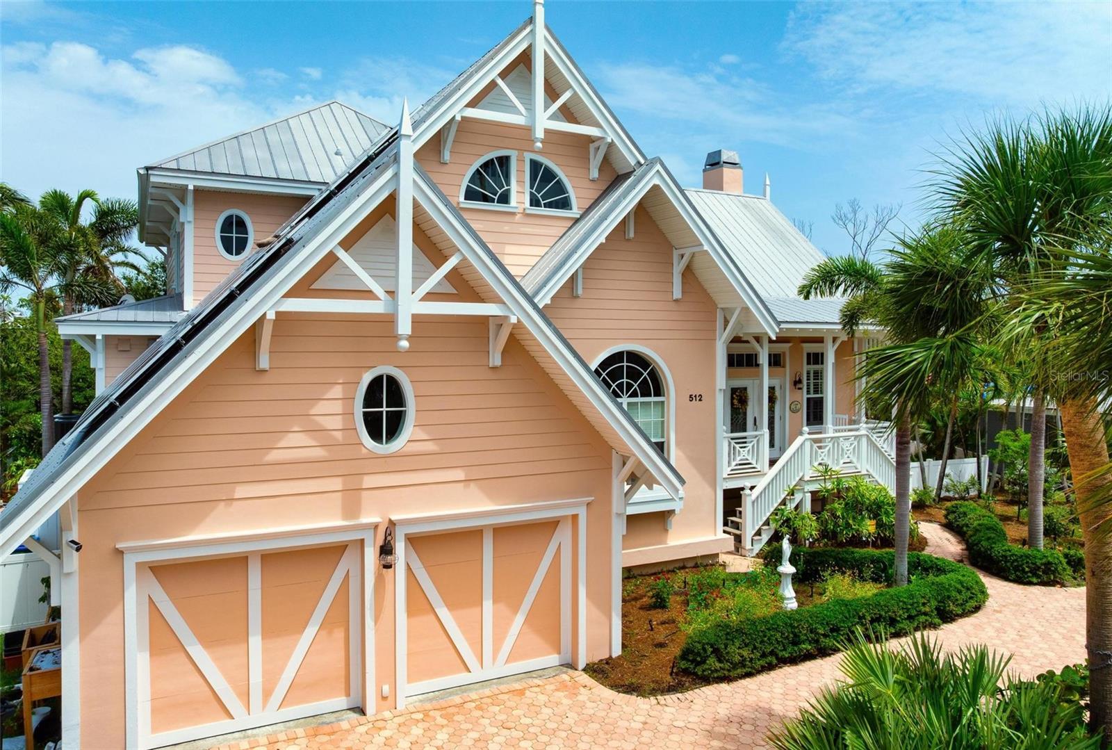 ~~~~~~~PRICE DROP~~~~~~~NOW is the time to buy this house. Make Anna Maria Island your own with a rare opportunity to own a truly iconic private island residence in Holmes Beach. Designed by celebrated architect Emily-Anne Smith, this distinctive home is recognized for its signature pink exterior, architectural integrity, and enduring coastal character.

Set along a deep-water canal with direct access through Bimini Bay to Tampa Bay, the property offers seamless access to Florida waters for boating, sailing, and fishing. The setting feels intentionally residential and private, ideal for those seeking a refined second home or a full-time island residence designed for personal enjoyment rather than rental use.

Offering nearly 2,800 square feet of interior living space and an additional 1,000 square feet under roof, the home provides generous proportions and thoughtful separation of spaces. A spacious screened porch overlooks protected mangroves, creating a naturally private backdrop and a peaceful connection to the island environment.

Inside, soaring cathedral ceilings, custom millwork, and a classic Craftsman-style fireplace highlight the quality and intention behind the original design. The chef’s kitchen is outfitted with a 6-burner WOLF range, SUB-ZERO refrigerator, BOSCH dishwasher, granite countertops, and a vegetable sink, offering a well-appointed foundation for both everyday living and entertaining.

The upper level features a versatile loft that includes a bedroom with ensuite bath, a recreation or lounge area, and a charming hidden treehouse retreat, adding character and flexibility to the home’s layout. The floor plan, construction quality, and architectural details provide an exceptional opportunity for a new owner to thoughtfully tailor the space to their own taste while preserving its timeless coastal appeal.

With its architectural pedigree, deep-water boating access, and quiet residential setting, this home invites a new owner to build upon its legacy and create a personalized island retreat that will endure for years to come. Schedule your private showing and experience the setting, serenity, and potential that make this a truly special Florida retreat.
