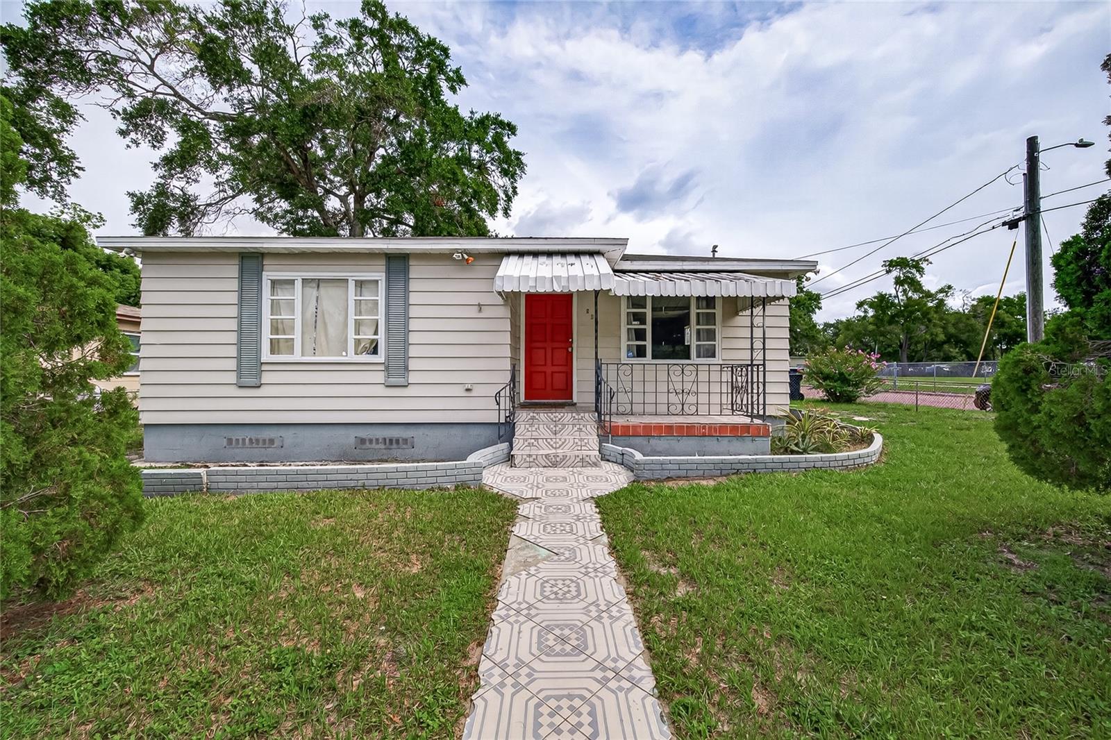 This 4-bedroom, 2-bath home offers incredible potential for both homeowners and investors. While it could use some TLC, opportunities like this are hard to find; especially with so few 4-bedroom homes in the area. The split-bedroom floor plan features two bedrooms at the front of the home and two at the rear for added privacy. A bonus room with its own private entrance offers endless possibilities as a 5th bedroom, home office, or guest room. The open kitchen overlooks the family room, and a built-in desk provides the perfect space for work or homework. Vinyl and tile flooring run throughout the home, and the oversized laundry room offers plenty of storage. Situated on a fully fenced corner lot with a side driveway and ample parking, this home is conveniently located just off I-275.  Great location with easy access to Seminole Heights, Downtown Tampa, Armature Works, the Riverwalk, Tampa International Airport, and Tampa Premium Outlets.

Bring your vision and make this home your own. Schedule your private showing today!