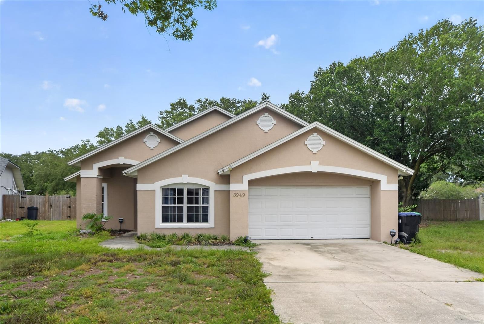 Located on a quiet cul-de-sac in Winter Park, this home has the kind of layout and lot that are hard to find at this price point. Vaulted ceilings open up the main living area, and built-in display niches along the wall give the space character you won't find in newer construction. The kitchen has a breakfast bar peninsula and connects to a sunny dining space with a pendant light overhead. 

The primary suite is generously sized with two windows, a ceiling fan, walk-in closet, and a private bath with a double vanity and soaking tub. A second full bath features detailed tile work and a vanity with granite-look countertops. Additional bedrooms have ceiling fans and solid closet space.

Out back is a large covered patio that opens to a fenced yard shaded by mature oak trees, the kind of backyard that actually works for people who want to spend time outside in Florida. There's room to run, entertain, or just let the week decompress.

All of this in Winter Park, minutes from Park Avenue dining and shopping, Rollins College, Winter Park Village, and with quick access to I-4 and downtown Orlando.