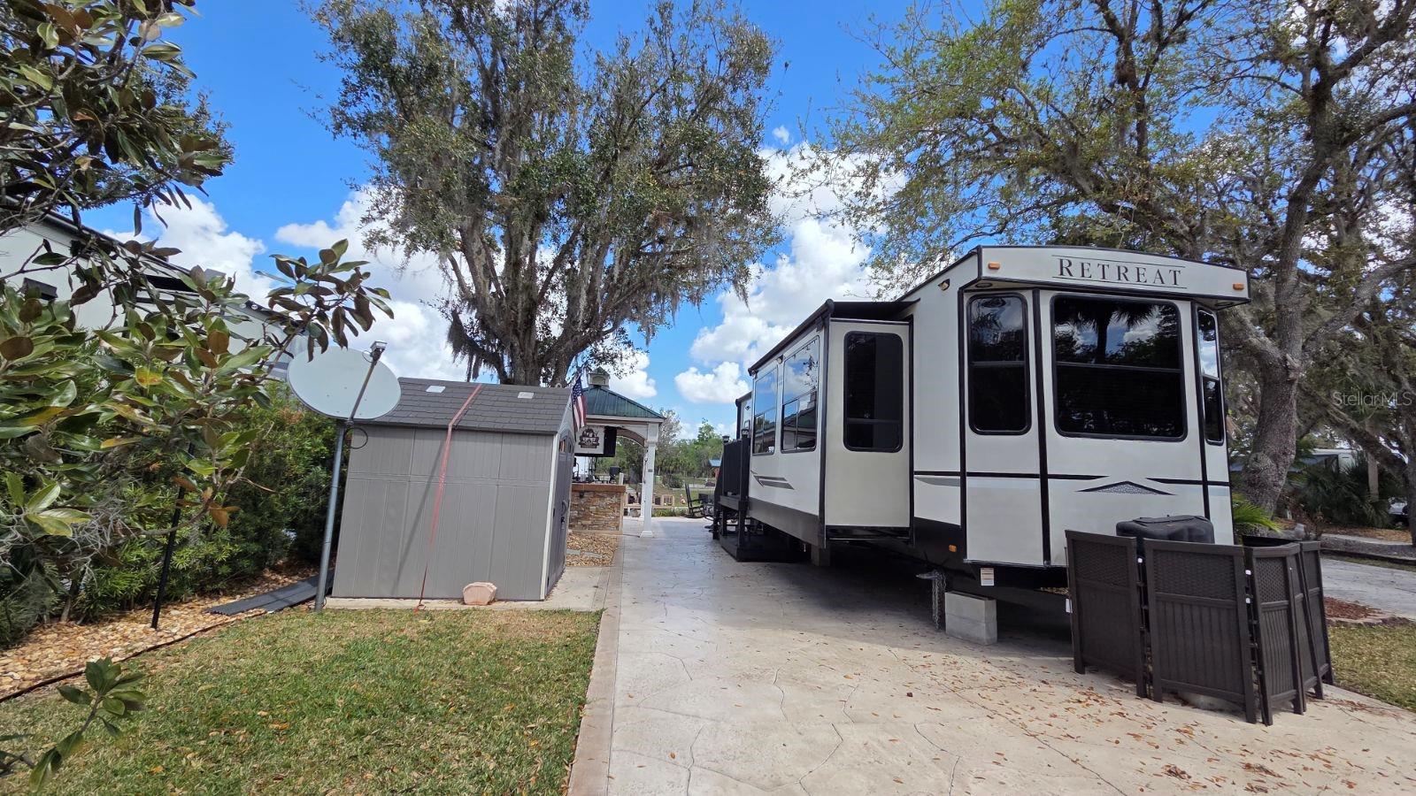 Experience the ultimate Florida lifestyle at 431 Waterway Drive, a rare turnkey opportunity featuring a direct waterfront lot and RV package deal! Situated in the highly coveted Phase 5 of River Ranch RV Resort, this spacious 40x92 big-rig friendly lot is move-in ready for personal use or immediate rental income. RV: 2021 Keystone Retreat Cottage - 391MKTS | 40’8”  Golf Cart:  2021 Yamaha 6 Seater | GAS.   A true boater’s dream, the property includes a private dock with direct access to the world-class Kissimmee Chain of Lakes. The expansive outdoor living space is anchored by a massive custom pavilion for all-weather camping, complemented by multiple seating areas, mature shade trees, and a full-sized storage shed. This premium lot offers enhanced privacy with a common area directly across the street, ensuring no immediate front neighbors.
River Ranch is Florida’s premier luxury RV destination located just one hour south of Orlando. The all-inclusive $942 quarterly HOA covers water, sewer, cable, internet, lawn care, trash, and 24/7 gated security. Owners enjoy exclusive access to a private lounge, billiards, poker room, and fitness center, while the resort offers endless entertainment including weekly live rodeos, a saloon with live bands, a waterpark, petting farm, and an adventure park. On-site dining options range from fine dining at the Chop House to waterfront BBQ and a Starbucks-serving coffee shop. Whether you are a snowbird or an investor, this pet-friendly paradise with no RV restrictions is a perfect fit.