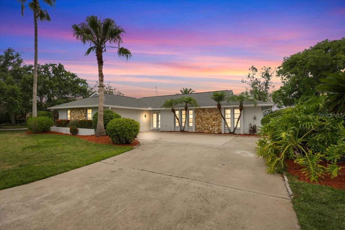 Imagine waking up every day to peaceful canal views, with 90 feet of waterfront, right from your own piece of Florida paradise with no rer neighbors. Located in the highly sought-after Gulf Harbors Woodlands, this 3-bedroom, 2-bathroom waterfront home features wood look plank tile throughout the home and a bright, open-concept floor plan designed for comfortable living and entertaining. The kitchen includes a huge central island that is perfect for meal prep, eat in dining, and gathering. As you enter the living room, you are invited by tall vaulted ceilings, an electric fireplace with decorative shelving on the sides, and an exceptionally long 6-panel accordion glass door that opens to the backyard.
Step outside onto the screened-in back porch, which also features tall vaulted ceilings, creating the perfect open space for you and your guests to sit and enjoy views of canal with direct deep water gulf access in minutes.. The outdoor area also includes a screened-in ground pool, and a private dock. The master bedroom includes a walk-in closet and an en suite bathroom with dual sinks, LED mirrors, and a tiled stand-up shower. The second bathroom also includes a dual-sink vanity and LED mirrors. The Gulf Harbors Woodlands community includes access to the clubhouse, community pool, and tennis courts and it offers you the option to join the private Gulf Harbors Beach for just $200 a year. Gulf Harbor Woodlands is a golf cart friendly community with easy access to downtown New Port Richey, and tons of restaurants shops and stores. Schedule your tour today!
