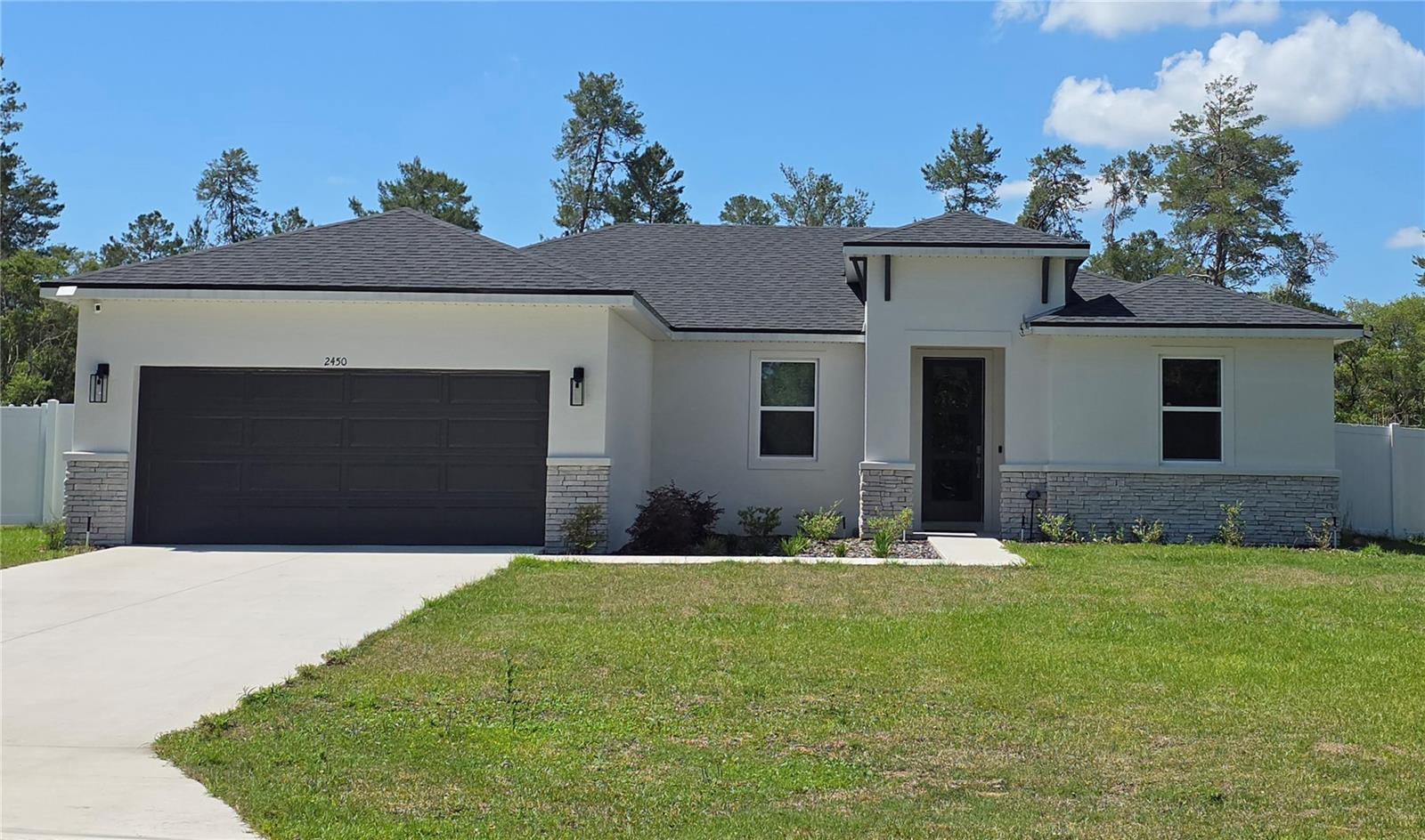 ONLY FOR THE MONTH OF JUNE 2026 THE RENT WILL BE $1k. Brite Sunrise Model by Brite Homes! Highly sought after Marion Oaks community! This beautifully single-story Ranch-style home sits on a generous 0.71-acre (3/4-acre) lot with no back neighbors, offering incredible privacy with a vinyl fence and room to enjoy Florida’s outdoors. Built in 2025 with durable concrete block (CBS) construction, stucco and stone accents, and a concrete slab foundation, this home is move-in ready. Inside, the 1,787 sq ft open-concept floor plan features 4 bedrooms, 2 bathrooms, and a split-bedroom layout perfect for families or guests. Soaring 9’4” ceilings, luxury tile plank flooring throughout, and an abundance of natural light creates a bright, airy feel. The chef’s kitchen shines with 36” real wood cabinets, elegant quartz countertops, stainless steel appliances, and a spacious island—ideal for entertaining. The master bedroom offers a large walk-in closet; this primary suite provides a true retreat. Energy efficiency is built in double-pane low-E windows to help control indoor temperature and reduce noise pollution, LED lighting, and a high-performance 16 SEER HVAC system deliver comfort and savings. This home achieves a strong HERS score of 53, translating to lower utility bills year-round. Outside, enjoy designer landscaping and a full irrigation system on this oversized irregular lot. The north-facing front elevation provides balanced light, while the open backyard is perfect for a future pool, garden, or simply relaxing under the stars. Additional highlights include a 2-car garage and modern finishes throughout. No HOA. No CDD. Just low-maintenance living with county-maintained roads and the convenience of the Marion Oaks MSTU for neighborhood services. Located in desirable Ocala, FL 34473, you’re minutes from shopping, dining, hospitals, and major highways, yet tucked away in a peaceful setting. This is new-construction living at its best—modern, efficient, and worry-free. Don’t miss your chance to own this exceptional home!