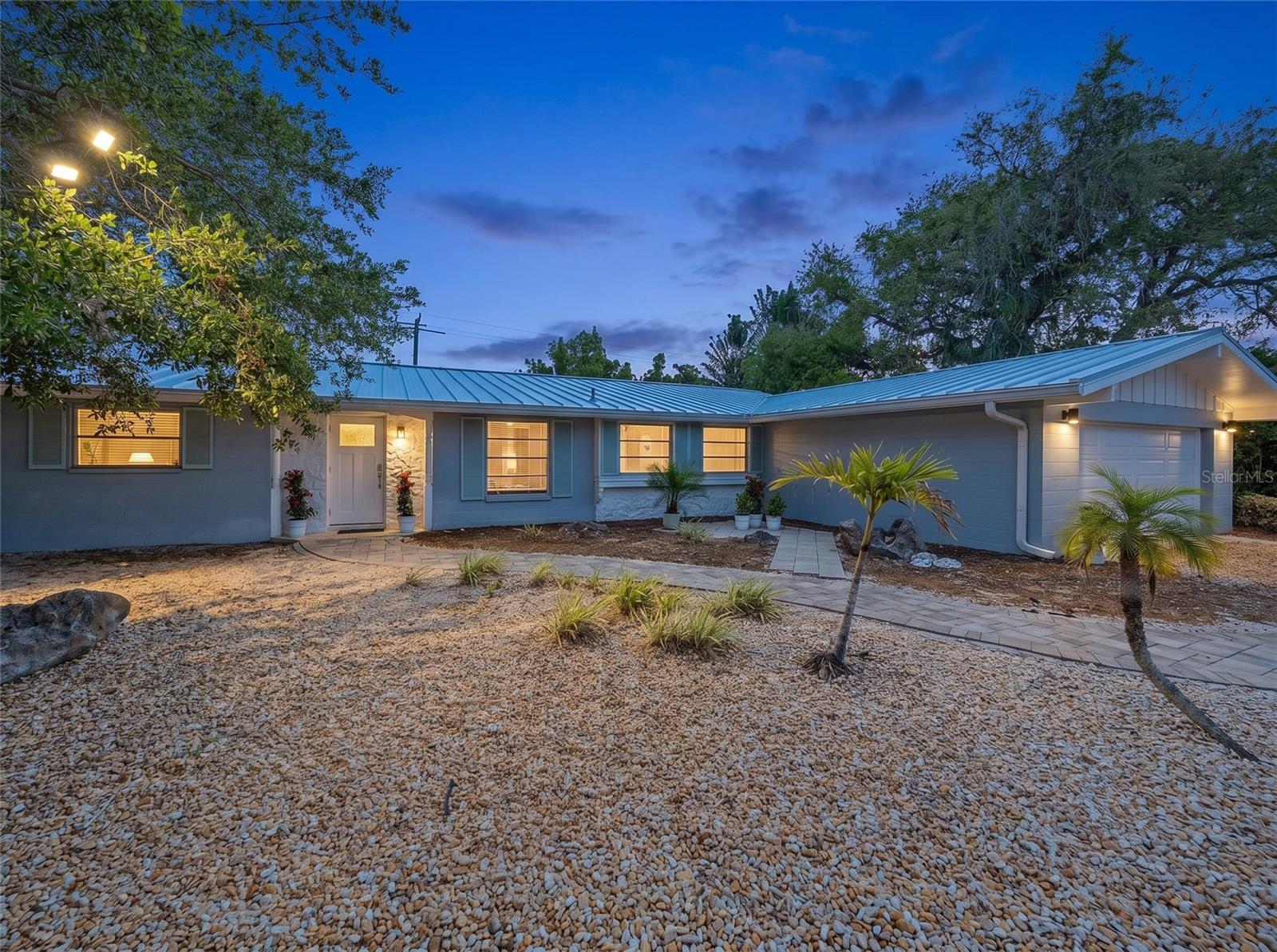 Island living meets easy everyday comfort in this turnkey furnished Siesta Key pool home. With 3 bedrooms, 2 bathrooms, approximately 2,168 square feet of living space and a 2-car garage, there is room for full-time living, a vacation getaway, or a high-demand rental.
Built of concrete block, this Ruth Richmond home offers peace of mind with major updates already done: brand new metal roof with warranty (April 2026), AC with warranty (August 2023), garage door (March 2025), front door (April 2025), and low-maintenance terrazzo flooring. Step inside to an inviting, well-planned layout with the primary suite on one side of the home with updated ensuite bath, and guest bedrooms on the other, offering privacy for family and visitors. The newly updated kitchen features granite countertops and modern finishes. The living room, dining area, and sunroom flow together seamlessly and overlook your private backyard oasis. 
Outside, enjoy your own sparkling, “sports pool” with a shallow area across the center, ideal for hosting friends for a game of pool volleyball, playing with the kiddos, or lounging. A brand-new fence with self-closing gates (April 2025) wraps the yard in privacy, creating a quiet retreat after a day at the beach.
Located on world-famous Siesta Key with low HOA fees of just $500 per year, you’re just minutes from the white quartz sand beaches, charming village shops and restaurants, boating, kayaking, and all the island lifestyle has to offer. This home combines an incredible coastal location with everyday convenience.
Turn the key, drop your bags, and start living the Siesta Key lifestyle at 611 Venice Lane.