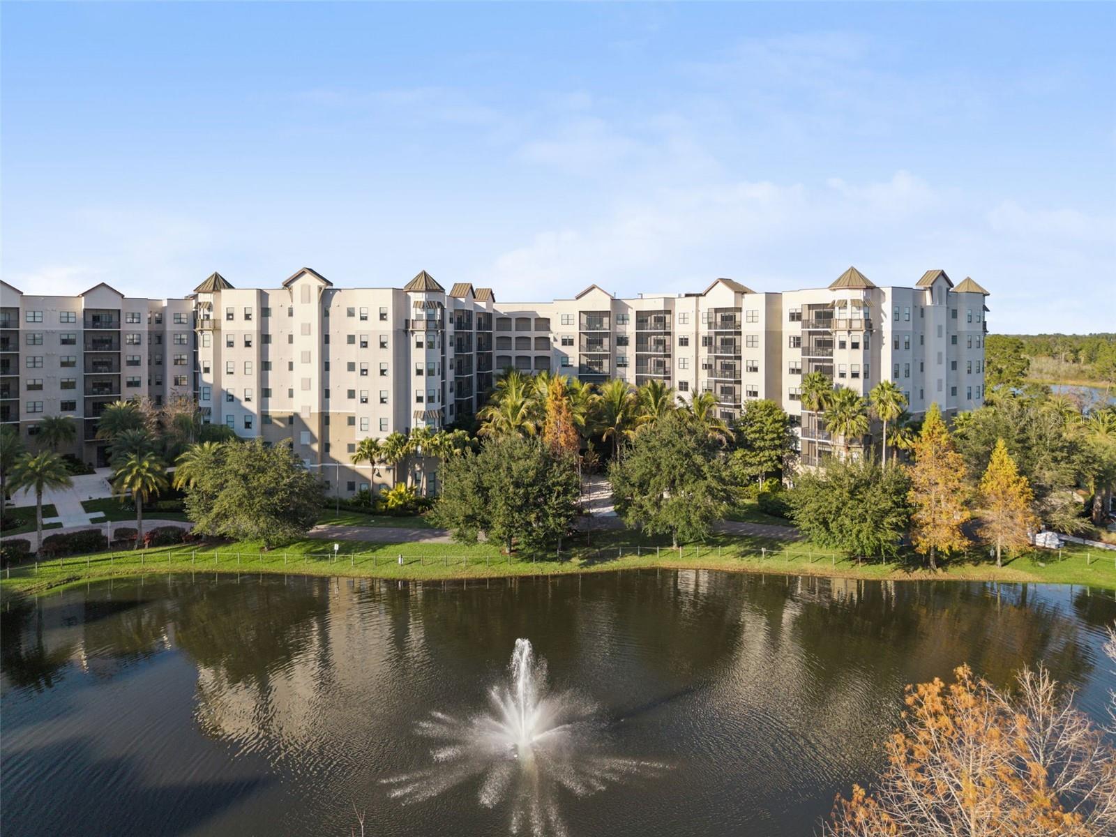 14K PRICE DROP | Ground Floor Unit | Pond and Fountain Views | Aggressively Priced Ground floor residence featuring 14 foot ceilings exclusive to first floor units, creating an open and spacious main living area. Ideally positioned within the community, the unit offers quick access to nearby resort amenities. Ground level units are often favored for vacation use due to convenient access without stairs or elevators. The screened private lanai overlooks a courtyard with pond and fountain views, framed by lush landscaping and mature palm trees. Interior features include stainless steel appliances, granite countertops, and a full size washer and dryer. The well designed split floor plan includes two bedrooms plus a pull out sofa, accommodating up to six guests. The community is professionally managed as a Condo Hotel, offering owners participation in an on-site rental program to help offset ownership costs when the unit is not in use. HOA fees conveniently covers all utilities as well as pest control, sewer, trash, and common-area insurance. Located within The Grove Resort & Water Park, a Disney World® Good Neighbor Hotel, owners and guests enjoy Surfari Water Park, FlowRider® surf simulator, fitness center, on site dining, walking trails, covered parking, lake access, and shuttle service to the Walt Disney World® Resort.
________________________________________