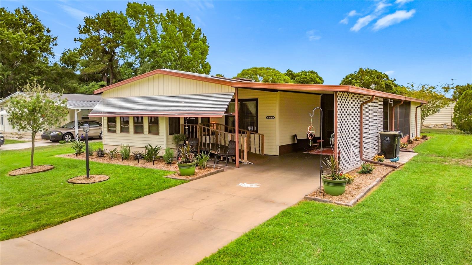 Check out this very spacious 1,404 sq. ft.  2 bed, 2 bath property which benefits from an enclosed front porch providing an additional 125 sq.ft under heat and air. In addition there is a large 11ft x 16ft vinyl room plus a generous 12' x 11' storage/workshop. Enter the home via the sturdy handicap accessible ramp into the open plan layout which offers a large living area open to the kitchen & dining area.  Both bedrooms are generously sized and offer ample closet space. Lots of possibilities .... Polo Park is a popular, well established 55+ community which offers many activities and amenities including 2 pools, 2 clubhouses, tennis & pickleball courts, shuffleboard, horseshoes, and fitness center. All for the low HOA fees of $70 per month! This wonderful community enjoys a great location directly off Hwy 27, minutes from 192 and easy access to to I-4, theme parks, grocery stores, medical facilities, restaurants, shopping, Margaritaville and more...DON'T MISS OUT!  Ask your agent to schedule a viewing today!