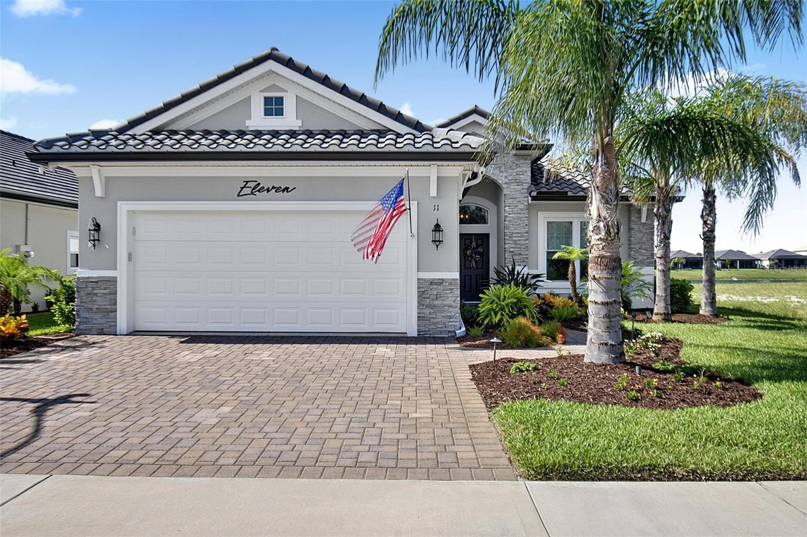 Gorgeous, saltwater pool home set in the relaxing Marina Del Palma community, where every home is paired with a dedicated dry boat slip in the private boathouse, along with concierge-style valet service, all included in the HOA. Unobstructed lake views unfold from the heated pool through the panoramic screened lanai, complete with a summer kitchen and covered patio outfitted with electric roll-down hurricane shutters. Oversized impact windows and sliders flood the open-concept floor plan with natural light. The living room's electric fireplace opens into a chef's kitchen featuring a 12-ft granite island, stainless steel appliances, soft-close cabinetry, under-cabinet lighting, and skylight. Every bedroom offers an en-suite or nearby bath with floor-to-ceiling tiled showers, while the primary suite features electric roll-down shades, a spacious walk-in closet, and en-suite bathroom. Rounding out the home are a dedicated office nook, tile roof, paver driveway, and fenced grass area. Marina Del Palma's resort-style amenities include a marina-front clubhouse, pool, spa, fitness center, tennis courts, and dog park, all just minutes from Flagler Beach, dining, shopping, and scenic walking/biking trails right across from the community.