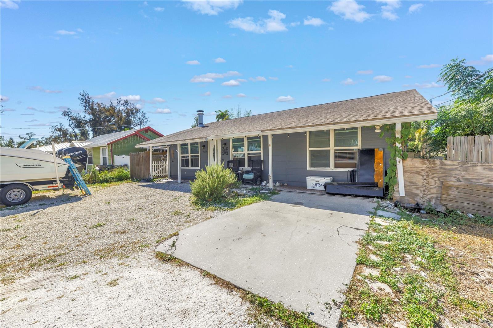 In a city where home prices often feel out of reach, this well-maintained three-bedroom, one-bath residence offers something increasingly rare: a real opportunity to plant roots in Sarasota without sacrificing location or potential. Set on a quiet, non-HOA neighborhood just minutes from the beach, downtown, shopping, and restaurants, this home proves that owning in Sarasota does not mean choosing between charm, location, and affordability. Inside, you will find an open layout with tile and laminate flooring, natural light throughout, and a warm, welcoming feel ready to be personalized. The kitchen has been thoughtfully updated with granite countertops and refreshed cabinetry that seamlessly blends function and simplicity, while unifying the living and dining areas. A cozy brick fireplace, featuring an above-mantel TV mount, anchors the living room, making it perfect for both quiet evenings with a book and hosting game day with friends. The primary bedroom features two closets and a dual-access ensuite bath that connects to the hallway leading to the home's two additional bedrooms. Step outside to a fully fenced backyard with a spacious deck, fire pit, and a large permitted shed that offers flexibility for storage or creative use, along with ample room for a home addition or pool, if desired. While it is not the biggest or flashiest house in town, it is real, it is ready, and it can be yours to shape. Whether you are a first-time buyer looking to stay in Sarasota on a budget, a seasonal visitor in need of a winter retreat, or someone who values authenticity, this is a home where you can begin to build not just equity, but a meaningful life. QUALIFIED BUYERS MAY HAVE THE OPPORTUNITY TO ASSUME THE EXISTING FHA LOAN AT A 2.9% INTEREST RATE. THIS RARE FINANCING OPTION COULD MEAN SIGNIFICANT MONTHLY SAVINGS COMPARED TO CURRENT MARKET RATES. ASSUMPTION IS SUBJECT TO LENDER APPROVAL AND BUYER QUALIFICATION. CONTACT THE LISTING AGENT FOR DETAILS.
