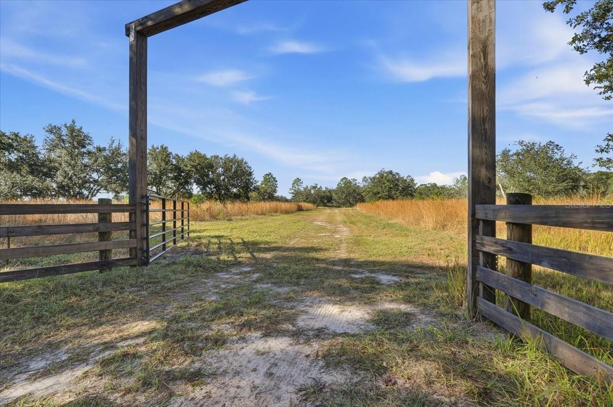 Extraordinary 142± Acre Agricultural Estate with Prime Road Frontage & Water Access. Discover this exceptional opportunity to own approximately 142 +/- acres of versatile, agriculturally classified land in the heart of Lake Wales in Central Florida. This expansive property offers the perfect blend of productive farmland, natural beauty, and prime development potential, making it ideal for agricultural operations, recreational use, or building your private dream estate. The property boasts over 3700 feet of road frontage on both State Route 60 and additional road frontage on Tiger Lake Road, with four separate gated entrances, providing outstanding access, flexibility, and future planning options. The Property can be subdivided, but it is currently utilized for yearly hay and timber production. Saw Palmettos grow naturally and can be harvested. Large portions of the land are cleared and fully workable, while other areas provide a scenic natural landscape abundant with grand mature Oak trees that make this property stunning. Water resources are a standout feature, with two private ponds located on the property, along with additional access to Weohyakapka (Walk-in-Water) Creek, which flows directly into Lake Rosalie—a prized feature for irrigation, livestock, or recreational enjoyment. Supporting agricultural and operational needs are three separate metal storage buildings, ideal for housing equipment, tools, and supplies. Existing large equipment may be negotiated separately, offering a turnkey opportunity for farming or land management. For peace of mind, the entire property is fully fenced with electric fencing, enhanced by security cameras, adding a functional layer of security. Wildlife enthusiasts will appreciate the abundance of native wildlife that regularly visits the land, while the property is well-suited for large farm animals, making it ideal for ranching, livestock operations, or equestrian use. Located in Lake Wales, a city known for its rolling hills, citrus groves, rich agricultural heritage, rodeo culture, and the iconic Bok Tower Gardens, the property enjoys a prime Central Florida location—approximately 50 miles south of Orlando—offering rural privacy without sacrificing accessibility. Whether you envision a working farm, timber investment, recreational retreat, or a stunning custom-built home surrounded by acres of privacy, this remarkable property delivers space, security, water access, and limitless potential. (10 adjoining parcels together with a combined acreage of 142.42) Third-party financing available.