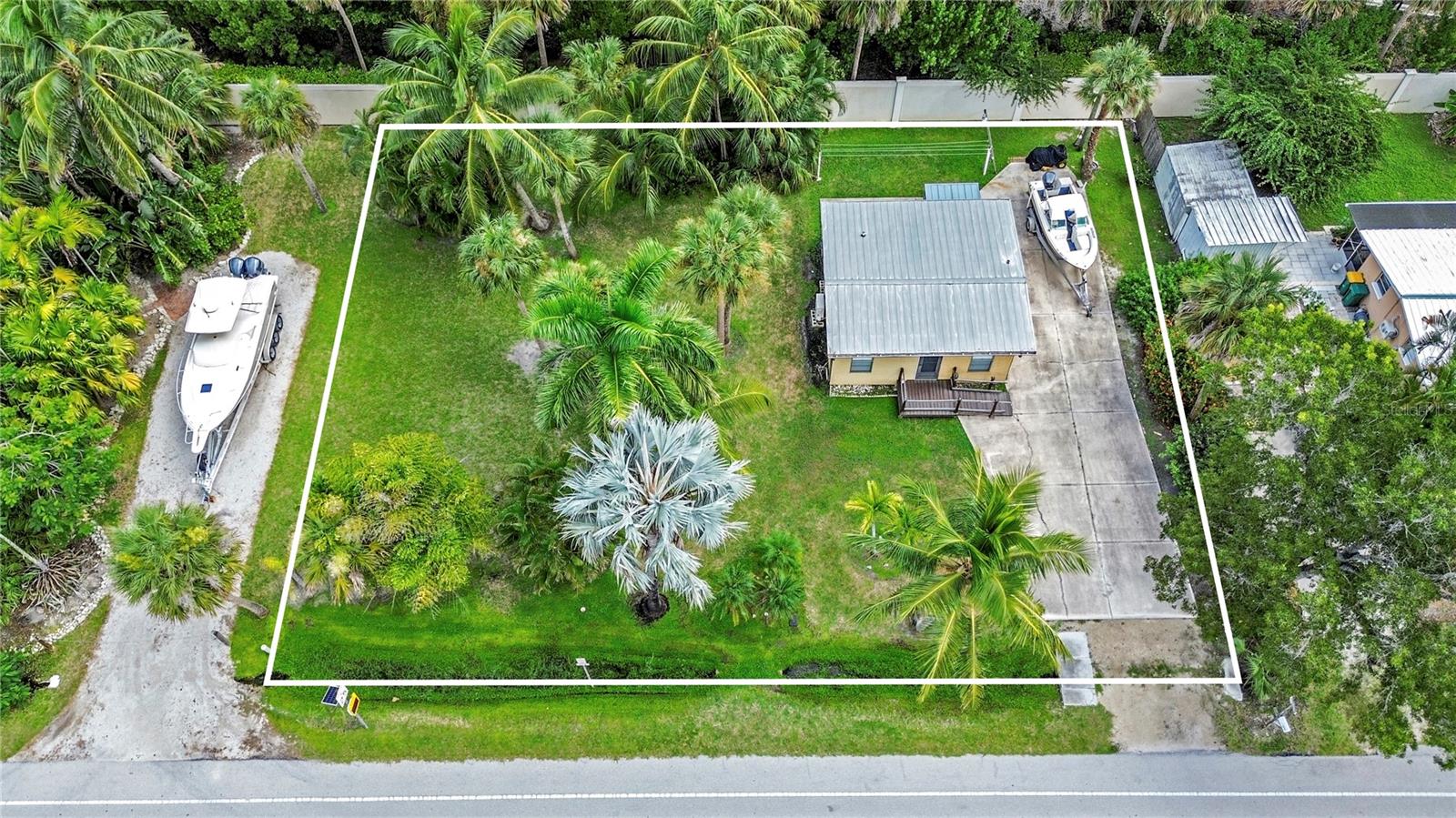 RARE triple-lot land opportunity in Naples Bayview, Lots 12, 13, and 14 repositioned specifically for creative investors, builders  or individuals seeking a NO-HOA, NO-CDD.  Bayview Park’s public boat ramp and marina at the end of the street—a significant advantage for boater-oriented buyers and income-producing concepts. This 120' x 83' parcel is presented as a premier redevelopment site, with the existing 1955 structure conveying as-is and priced strictly for land value.  The triple-lot has excellent flexibility for a custom coastal home, duplex configuration, or multiple cottage/tiny-home concepts, subject to Collier County approval. With water and sewer already connected, development timelines and upfront costs can be reduced compared to unimproved land, and the open layout allows for creative site planning  and separation between structures.    Located in one of Naples’ most active coastal corridors, near some of Naples' most established waterfront communities, the property sits near the yacht basin, backs up to Windstar, cruise around Port Royal or Keewaydin Island.  Your just minutes from the Bayshore Arts District, Celebration Park, Naples Botanical Garden, Tin City, and 5th Ave S. Few parcels combine this land size, design freedom, and walkable access to a public Gulf-launch facility. Buyer to verify zoning, density, setbacks, flood requirements, rental regulations, and intended use. Far and few opportunities to have land this close to the water with no HOA - NO CDD.