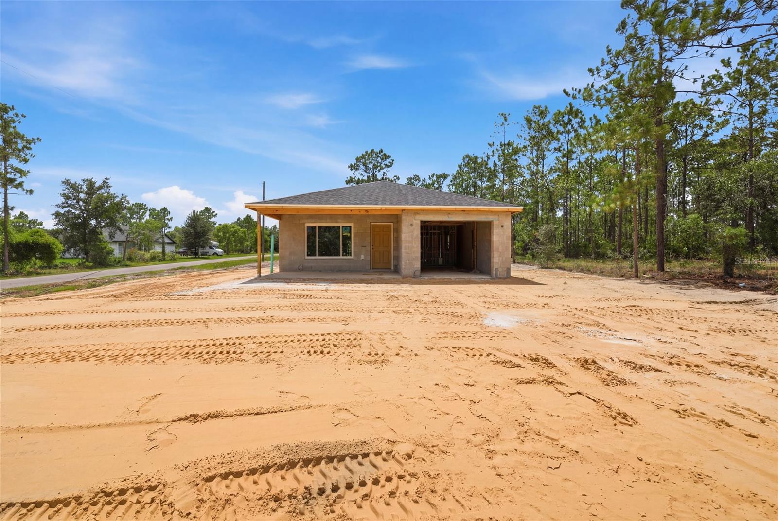 Under Construction. Welcome to this charming new construction home in the sought-after Williston Highlands Golf & Country Club Estates, built by Shamrock Construction and thoughtfully designed with the Daylight floor plan. This 2 bedroom, 2 bathroom home offers 1,353 square feet of heated living space and a functional, low-maintenance layout perfect for first-time buyers, downsizers, or anyone seeking a fresh start in a quiet community setting.
Step inside to find a bright living room and dining room combo, ideal for both everyday living and entertaining. The kitchen comes equipped with a dishwasher, microwave, range, and refrigerator. The primary bedroom features a walk-in closet, while the second bedroom offers a built-in closet for added storage. LVP flooring runs throughout, paired with central air and heat for year-round comfort.
Outside, enjoy a covered front porch, an attached one-car garage, and durable stucco construction topped with a shingle roof. 
This home is currently under construction with a projected completion date of August 29, 2026, giving buyers the opportunity to secure a brand new home in a growing area of Levy County. With no HOA fees and a peaceful country setting, this is a rare chance to own new construction at an attractive price point.