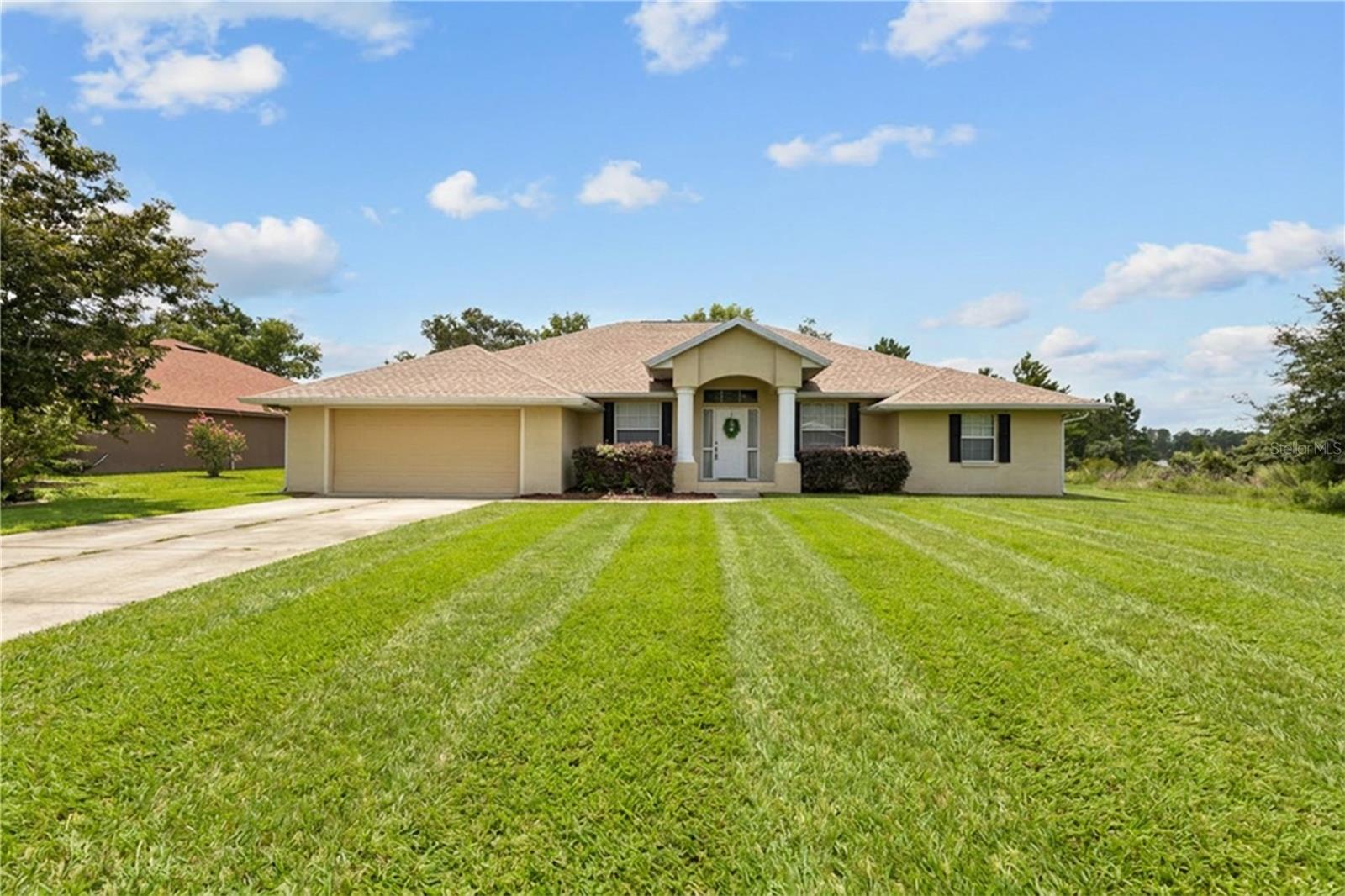Welcome to 5320 SW 115th Loop, a spacious 4-bedroom, 3-bath home located in Kingsland Country Estates in desirable southwest Ocala. Offering nearly 2,600 square feet of living space on a generous 0.40-acre lot, this one-story home provides the space, layout, and flexibility buyers are looking for.

Inside, the home features an open floor plan with a comfortable flow between the main living areas, making it well-suited for everyday living and entertaining. The cathedral ceiling adds volume to the main living space, while the combination of tile and luxury vinyl flooring offers a practical, low-maintenance finish throughout key areas of the home. With four bedrooms and three full bathrooms, the layout works well for larger households, guests, multigenerational living, or anyone needing extra room for a home office, hobby space, or flex room.

The primary suite offers privacy and separation from the additional bedrooms, while the secondary bedrooms provide plenty of options for family, guests, or workspace needs. The third full bathroom is a major functional advantage, giving the home added convenience and making the floor plan more usable than a typical 4-bedroom, 2-bath layout.

Outside, the property sits on just under half an acre, giving you more outdoor space than many standard neighborhood lots. The 2-car attached garage provides parking and storage, while the yard offers room to enjoy the Florida lifestyle without feeling crowded.

The location is another major highlight. Kingsland Country Estates offers a residential setting with convenient access to SR 200, Cherrywood Publix, Liberty Park, shopping, dining, medical services, and southwest Ocala amenities. Whether you are looking for more space, a practical layout, or a well-located Ocala home with room to grow, this property deserves a serious look.
