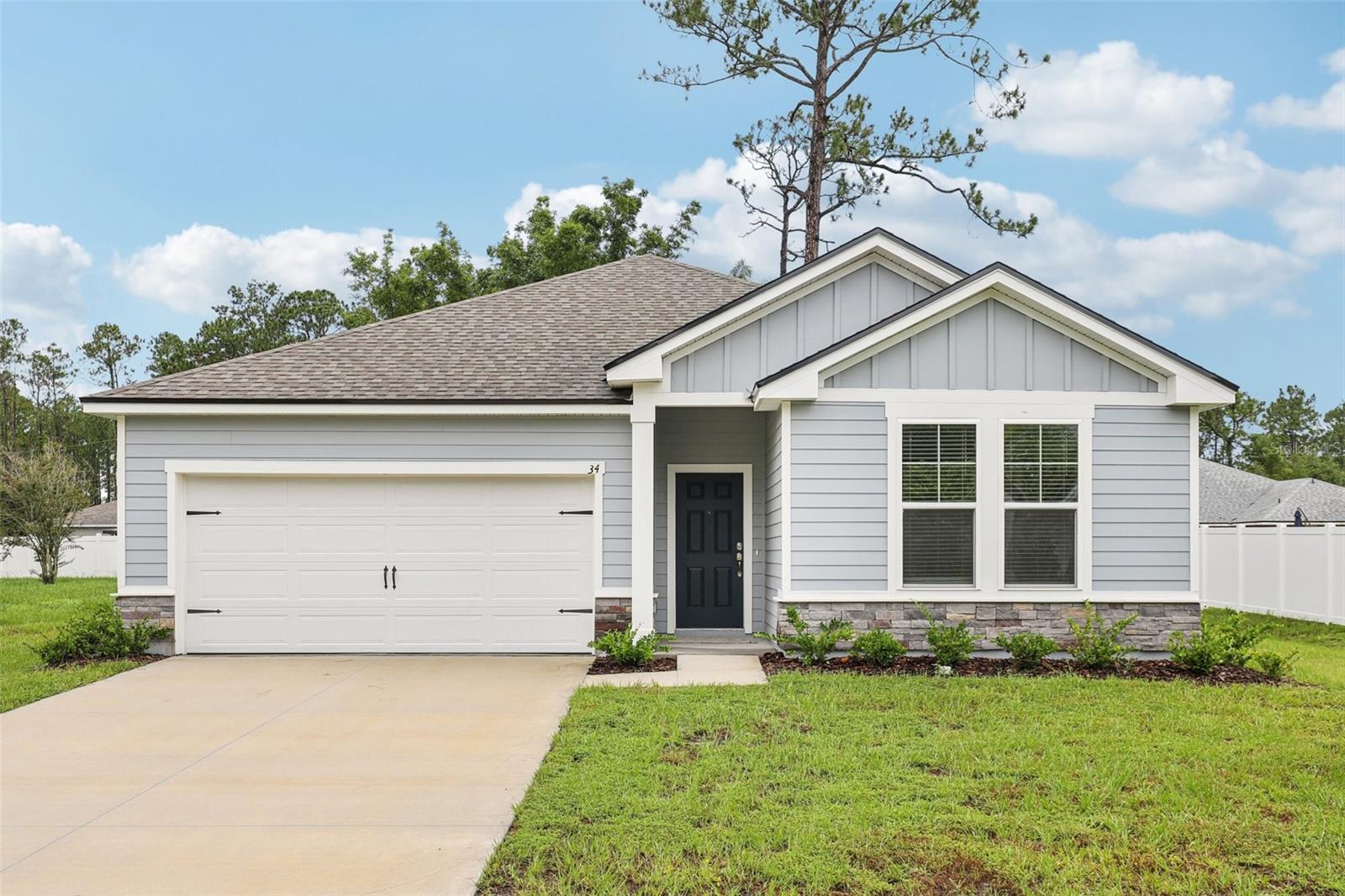 Virtually Staged. Unbeatable builder closeout opportunity in Palm Coast! Ask about builder incentives to cover your closing costs or special interest rate promotion!  One or more photos has been virtually staged. This brand-new construction home by Brightland Homes features 3 bedrooms and 2 baths, plus a pocket office ready for your home office, gym, craft room or more!  A tasteful board and batten and stone exterior leads into this split bedroom open concept floor plan featuring neutral finishes, luxury vinyl plank flooring, and plenty of natural light.  The kitchen is a chef’s dream, complete with a full suite of stainless-steel appliances, quartz countertops, pantry, and large island overlooking the spacious living and dining areas. Tucked away in the rear of the home, the Primary Suite is a private sanctuary complete with dual vanities, quartz countertops, large walk-in shower, gleaming chrome fixtures, and a walk-in closet with plentiful shelving.  Sliding glass doors lead to your spacious backyard, which is ready for your special touch. With plenty of room for a pool, expanded covered lanai, playscape, etc. – the options are endless!  Entertain your friends and family with ease, all while enjoying the comforts and conveniences of everyday living. No HOA or CDD fees! Centrally located near schools, shopping, grocery, medical, beaches and recreation with easy access to US1 and I-95. Don’t miss the opportunity to live the Palm Coast lifestyle and call 34 Reidsville Drive home!
