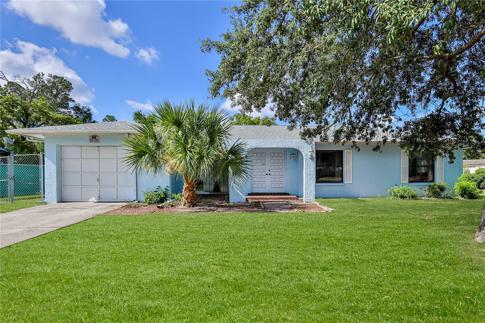 This inviting three-bedroom, two-bath pool home offers a thoughtfully designed split-bedroom floor plan and is located on a corner lot. Step through the double front doors into a spacious living room featuring luxury vinyl plank flooring, a ceiling fan, and sliding glass doors that open to the covered screened lanai, creating seamless indoor-outdoor living. The bright kitchen serves as the heart of the home with wood cabinetry, tile flooring, a gas stove, new dishwasher, coffee bar, double sink, and a window overlooking the sparkling pool. Adjacent to the kitchen, the sun-filled dining area is surrounded by windows. The private owner's suite features a large closet, ceiling fan, sliding glass doors leading to a secluded patio, and an updated en-suite bathroom with a new vanity, commode, and beautifully tiled walk-in shower. Two additional guest bedrooms include ceiling fans, ample closet space, and abundant natural light. The guest bathroom has also been updated with a new vanity and commode. Outdoor living is a standout feature of this home. Enjoy relaxing under the covered screened lanai or take a refreshing swim in the resurfaced pool with multiple depth levels, all enclosed by a screened pool cage with newer screens. The fully fenced backyard offers privacy, a garden area, patio space, a 10' x 16' shed with electricity and double-door access, ideal for a workshop, hobby space, or extra storage. The one-car garage has space for parking, laundry, and storage. Major updates include a 2023 roof, 2023 HVAC system, resurfaced pool, and newer pool screens, providing peace of mind for years to come. Bring your boat, RV or camper! NO HOA. Move-in ready. Schedule your private showing today!