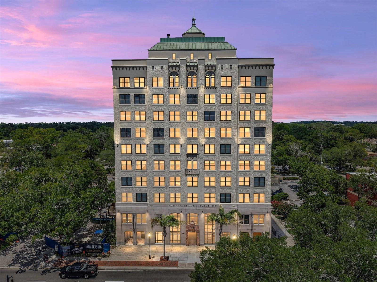 Incredibly rare opportunity to own a luxury upper-floor condo in the historic, newly refurbished Seagle Building! This stunning 2-bedroom, 2-bathroom unit was fully renovated just a few years ago and offers modern comfort in one of the oldest and most iconic Gainesville buildings. Enjoy a large combined living and dining area on one of the building’s highest floors, featuring tile and simulated wood flooring throughout — NO CARPET. The remodeled kitchen, just off the main living space, showcases white shaker cabinets, stainless steel appliances, granite countertops, and an oversized island. The primary suite includes a generous walk-in closet and a beautifully updated bathroom with designer tile. The unit also features a new AC system, meaning that a major expense has already been taken care of for you. This unit is also one of the few that includes two reserved parking spaces in the integrated garage (a $20,000 upgrade). The building recently benefited from a significant capital improvement project and now looks better than ever, with a newer roof, fresh exterior paint, brand-new windows throughout, and extensive updates to the building HVAC system. Located in Downtown Gainesville, less than one mile from the University of Florida and steps from local favorites like Bo Diddley Plaza and top restaurants including Dragonfly, Harry’s, and Mark’s Prime. Easy access to UF, Shands Hospital/UF Health, and Innovation Square. The work has already been done… move right in. Units in this building are rarely for sale, so be sure to book your private tour ASAP.