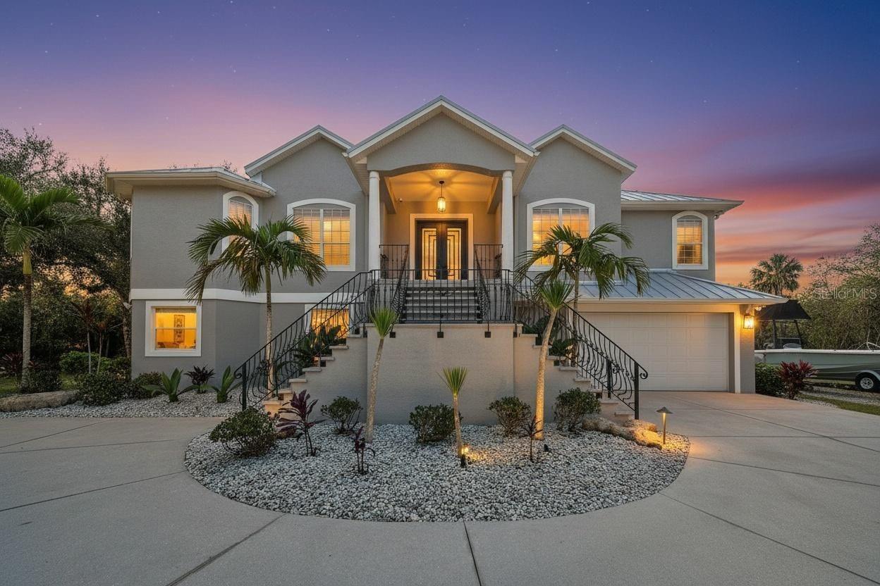 A rare opportunity to own over 5 acres in the Tampa Bay area—where privacy, space, and convenience come together in a way that’s nearly impossible to find. Tucked behind a private gated entrance and long driveway, this exceptional estate offers security, seclusion, and the peaceful setting buyers dream about, while still being just minutes from shopping, dining, beaches, and everyday essentials.
The upstairs main living level truly feels like the heart of the home, designed to make both everyday living and entertaining easy. Here you’ll find a spacious primary suite, two additional bedrooms, and a dedicated home office that works perfectly for remote work or study. The kitchen flows naturally into the living areas and is complemented by a convenient dry bar, while an indoor laundry room and abundant storage add practical comfort. Tray ceilings, natural light, and large sliding doors open to an elevated porch overlooking the property, all protected within a dramatic two-story screened birdcage—perfect for enjoying the outdoors without sacrificing comfort.
The outdoor living experience continues on the lower level of the screened enclosure, where a fully equipped outdoor kitchen with a built-in grill and Green Egg creates an ideal space for entertaining. The backyard includes a large fenced area ideal for outdoor play, recreation, or pets, while the property itself extends well beyond the fenced portion—providing over five acres of usable land, privacy, and possibilities rarely found this close to Tampa Bay amenities.
Thoughtfully designed to live like two homes in one, the residence offers exceptional flexibility for multigenerational living, extended guests, or lifestyle versatility. The entire lower level functions as a true second living space, featuring its own full kitchen, living area, additional dry bar, large locked storage closet, a fourth bedroom, and a spacious bonus flex room currently used as a gym and playroom. A second laundry area, conveniently accessible from the screened porch, adds everyday practicality.
Major recent upgrades provide peace of mind and long-term value, including a new metal roof and new HVAC system, allowing the next owner to focus on enjoying the property rather than tackling big-ticket improvements.
This rare Tampa Bay acreage estate delivers privacy, flexibility, and location in one exceptional opportunity. For the buyer seeking space to breathe, room to entertain, and a home that adapts to real life—without sacrificing proximity to everything the area has to offer—this property is truly something special.