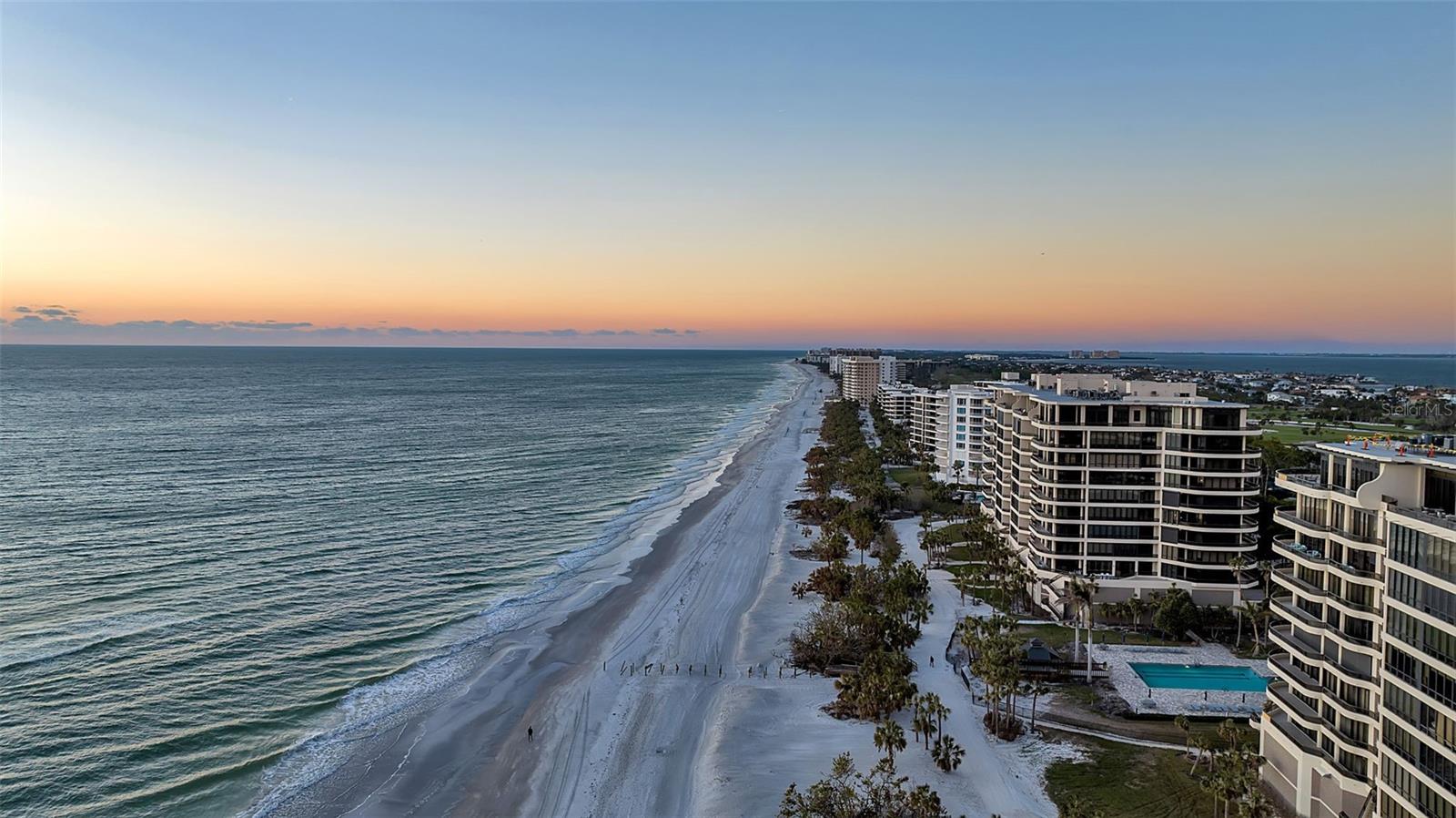 Choice Southwest corner-  enjoy sunrise to sunset views!  Welcome to L’Ambiance, where every day is a holiday. — This residence is the gem of all jewels,  a Crown of Coastal Elegance and the epitome of refined luxury living! Discover the true essence of a sophisticated coastal lifestyle at L’Ambiance, where every detail has been meticulously curated to offer unparalleled elegance, comfort, and breathtaking beauty. Nestled just moments from the prestigious Longboat Key Club, residents enjoy access to 45 holes of championship golf, world-class tennis, exquisite dining, a rejuvenating spa, and the second-largest marina on Florida’s west coast. This extraordinary residence is a masterpiece of architectural brilliance and contemporary design, thoughtfully and recently updated to perfection. Step inside this Southwest corner home and be captivated by sweeping panoramic vistas that stretch from the shimmering waters, with sunsets over the Gulf of Mexico, Sarasota Bay, and the vibrant downtown skyline, as well as sunrise and moonrise. These awe-inspiring views set the perfect backdrop for a lifestyle of effortless sophistication and tranquility. Your journey begins with a private elevator that opens directly into a stunning, updated home, featuring windows and sliding glass doors that meet the latest hurricane code. Enjoy a 3,380 sq. ft. sanctuary, where light floods through expansive floor-to-ceiling glass sliders, illuminating an open-concept living and dining area that seamlessly combines style with functionality. Designed for entertaining and everyday living alike, the sleek interiors feature a chef-inspired kitchen with a captivating waterfall-edge island—truly the heart of the home and a testament to culinary artistry. The residence boasts three generously sized bedrooms en-suite, thoughtfully positioned in a split layout to ensure maximum privacy and serenity. The primary suite is a private retreat flooded with natural light and features sliding glass doors that open onto a spacious terrace. Here, you can enjoy your morning coffee while soaking in stunning vistas of the Gulf of Mexico and Siesta Key in the distance. The en-suite primary bathroom is a spa-like sanctuary, offering an indulgent escape with views of the gulf and luxurious finishes and fixtures. We also have a versatile bonus room wing that offers additional space with queen-size bunk beds for children or a private retreat. L’Ambiance offers unrivaled amenities designed to elevate every aspect of luxury living. Residents enjoy a 24-hour manned gated community, concierge service, security, an on-site manager, a resort-style heated Olympic-size pool and spa, a state-of-the-art fitness center, outdoor BBQ areas, three social rooms, and three overflow guest suites available on a first-come, first-served basis. Included are 2 upper-level under-building parking spaces and storage. This pet-friendly community is dedicated to making every detail perfect, delivering a lifestyle that is as effortless as it is extraordinary.