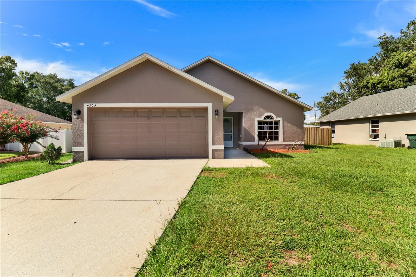 Welcome! This 3-bedroom, 2-bathroom home sits in a central location with direct connectivity to shopping, dining, recreation, and healthcare. The property combines practical interior finishes with outdoor living and a two-car garage, all positioned minutes from the Florida Turnpike, major roadways, and local amenities. Inside, easy-to-clean tile flooring runs through the kitchen, dining room, living room, hallways, and both bathrooms, while warm, luxury vinyl plank flooring covers the bedrooms. A vaulted ceiling in the main living area and a cathedral ceiling in the primary suite add to the home, offering a light and airy feeling. The screened lanai extends the living space outdoors, creating an additional area for relaxation and entertaining no matter the weather. Its fenced backyard provides privacy and even more space for outdoor activities, whether for pets, gardening, or get-togethers. Location is a major strength here. The home sits near Florida Turnpike entry points for easy commuting and travel throughout Central Florida. Lakefront Park is nearby for recreation and community events, while multiple shopping centers provide immediate access to retail options and services. A Walmart Supercenter is minutes away for comprehensive shopping needs, along with Publix Super Market for everyday groceries and pharmacy services. Golf enthusiasts will appreciate proximity to both Royal Links and Remington Golf Club, offering different course styles. For outdoor exploration, Twin Oaks Conservation Area is close by with hiking trails and nature observation opportunities, and Whaleys Landing Public Boat Ramp provides convenient lake access. Healthcare needs are well-served with Orlando Health Hospital nearby. The local Parks and Recreation facilities round out the neighborhood's appeal with sports courts, athletic fields, a pool, splash pad, playground, and community programming. Schedule your private showing today and experience this well-positioned home firsthand.